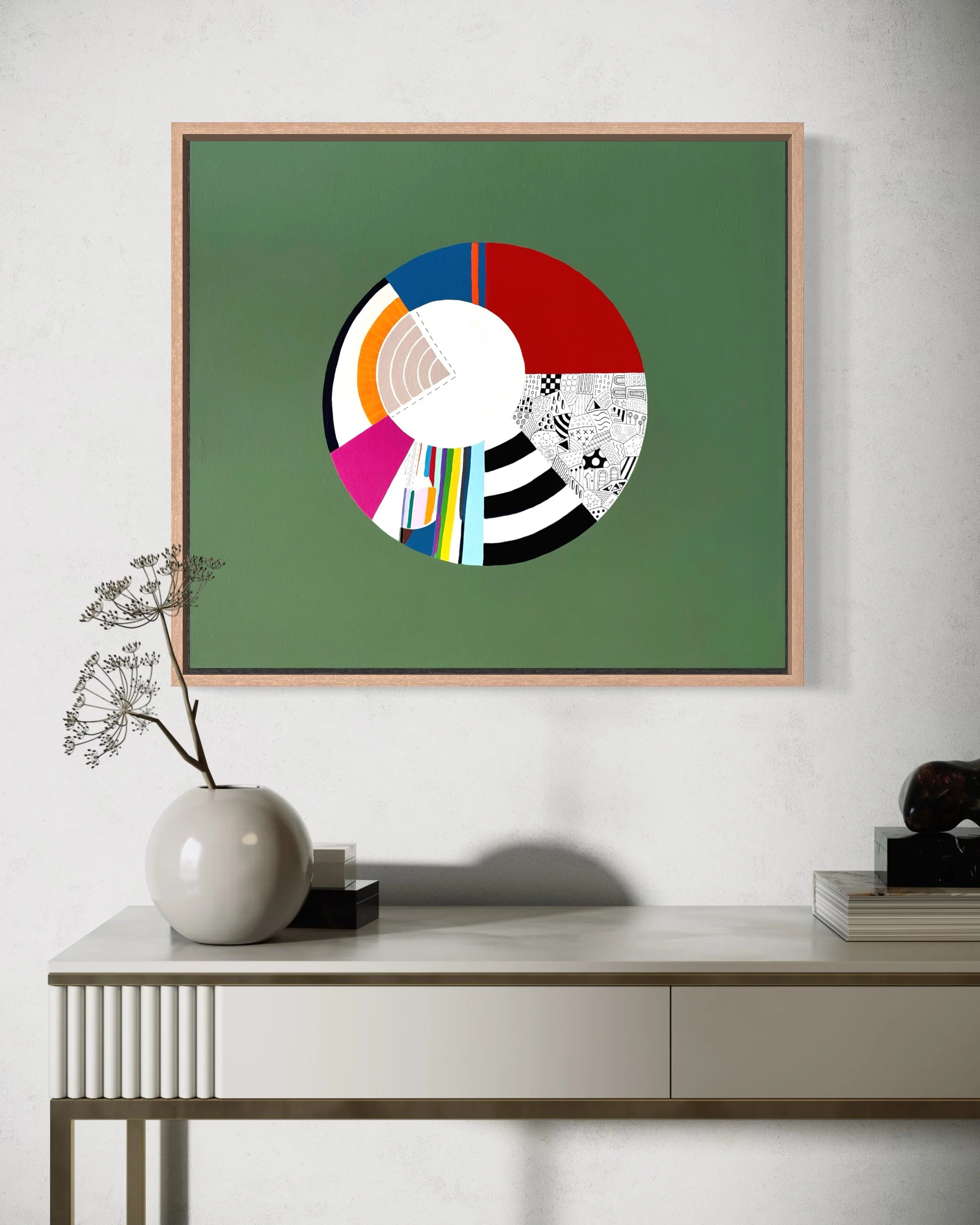 Off Centre, original abstract artwork on canvas with a colourful circular composition, radiating sections and an off-centre white circle on a jade green background, styled in a modern interior.