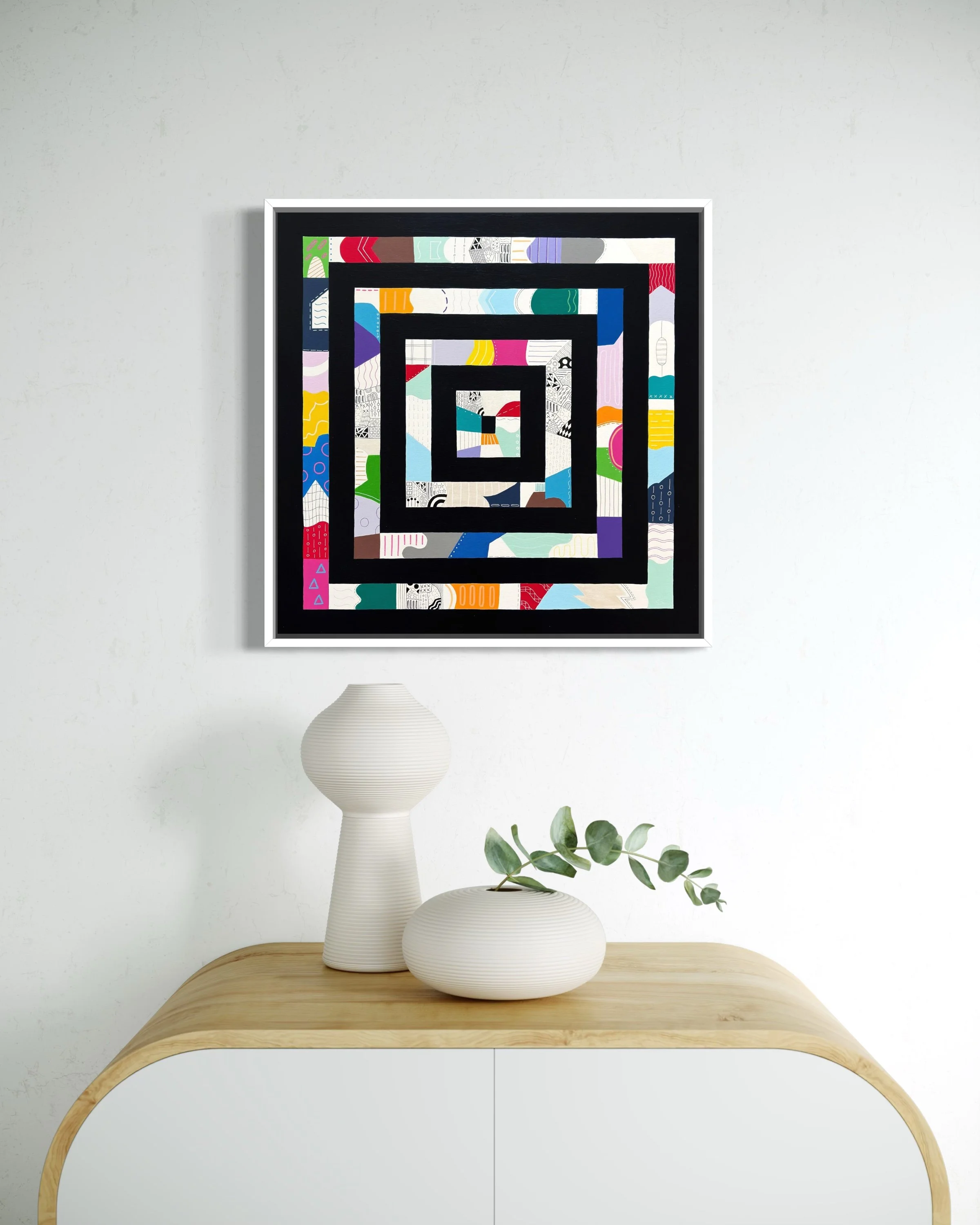 Freedom Within Boundaries, original abstract artwork on canvas featuring nested square frames in Paynes grey filled with bold, playful patterns and colour, styled above a modern table.