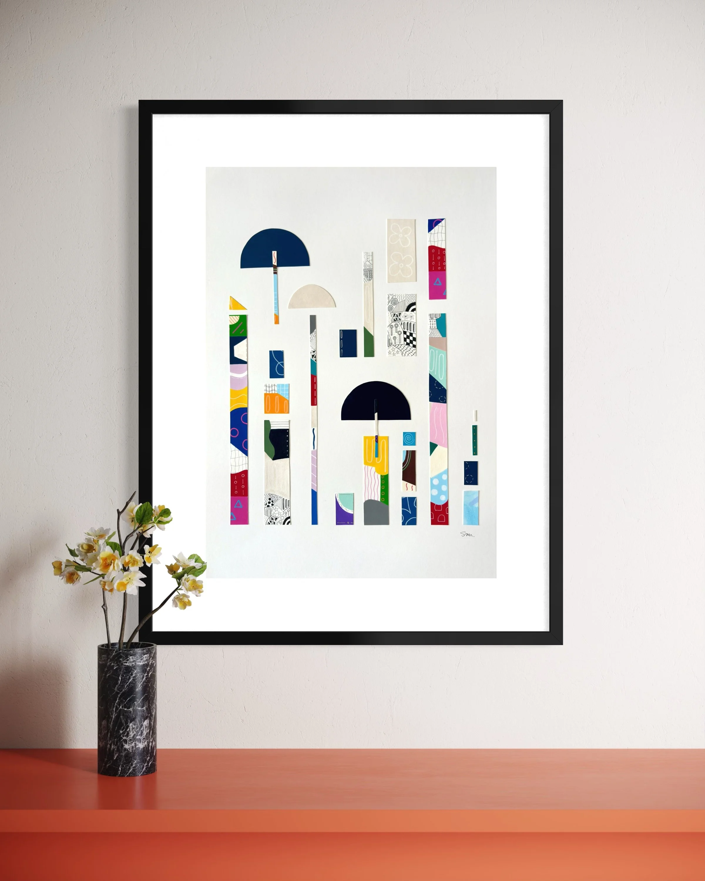 Between Play and Order, original mixed media on A2 paper with geometric and abstract forms, colour, pattern, and hand-drawn marks, styled in a modern interior.