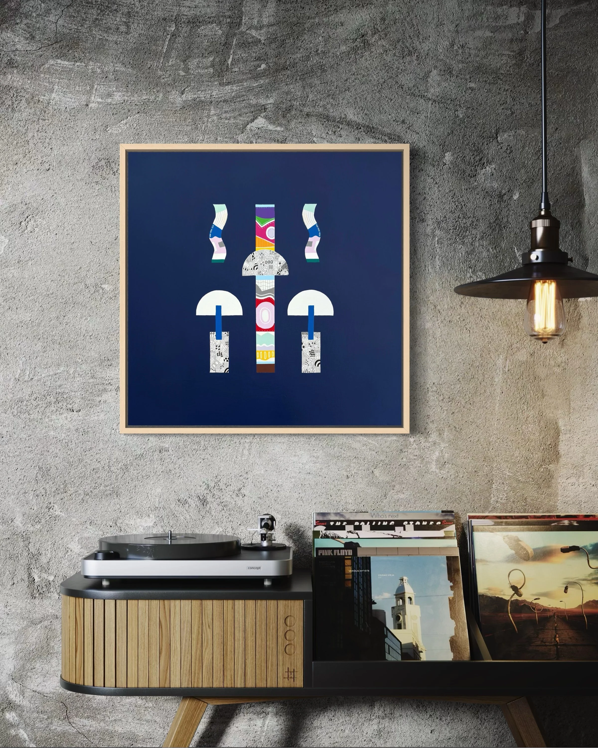 Mostly In Place, original mixed media abstract on canvas with a dark blue background, displayed in an oak frame on a concrete wall above a record player.