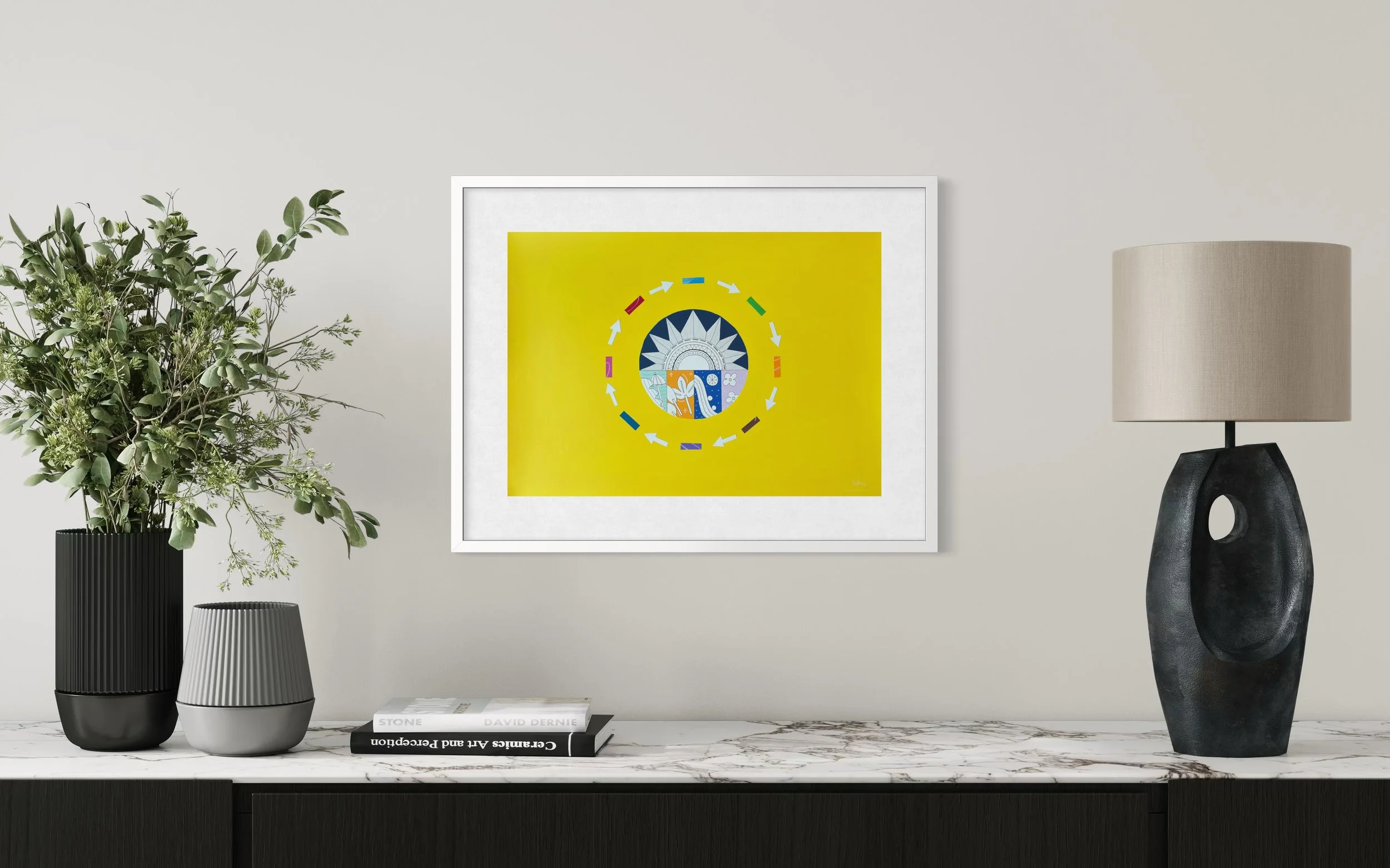 A Most Colourful Year Around the Sun, original mixed media on A2 paper with a yellow background featuring a sun, seasonal panels, and arrows, framed and displayed above a sideboard.