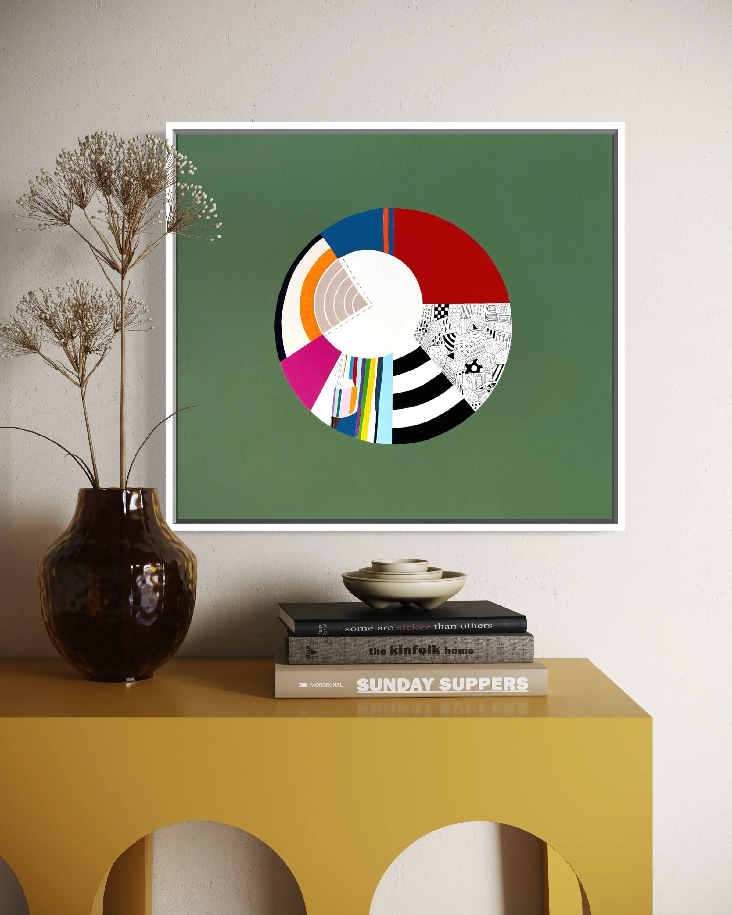 Off Centre, original abstract artwork on canvas with a colourful circular composition, radiating sections and an off-centre white circle on a jade green background, styled in a modern interior.