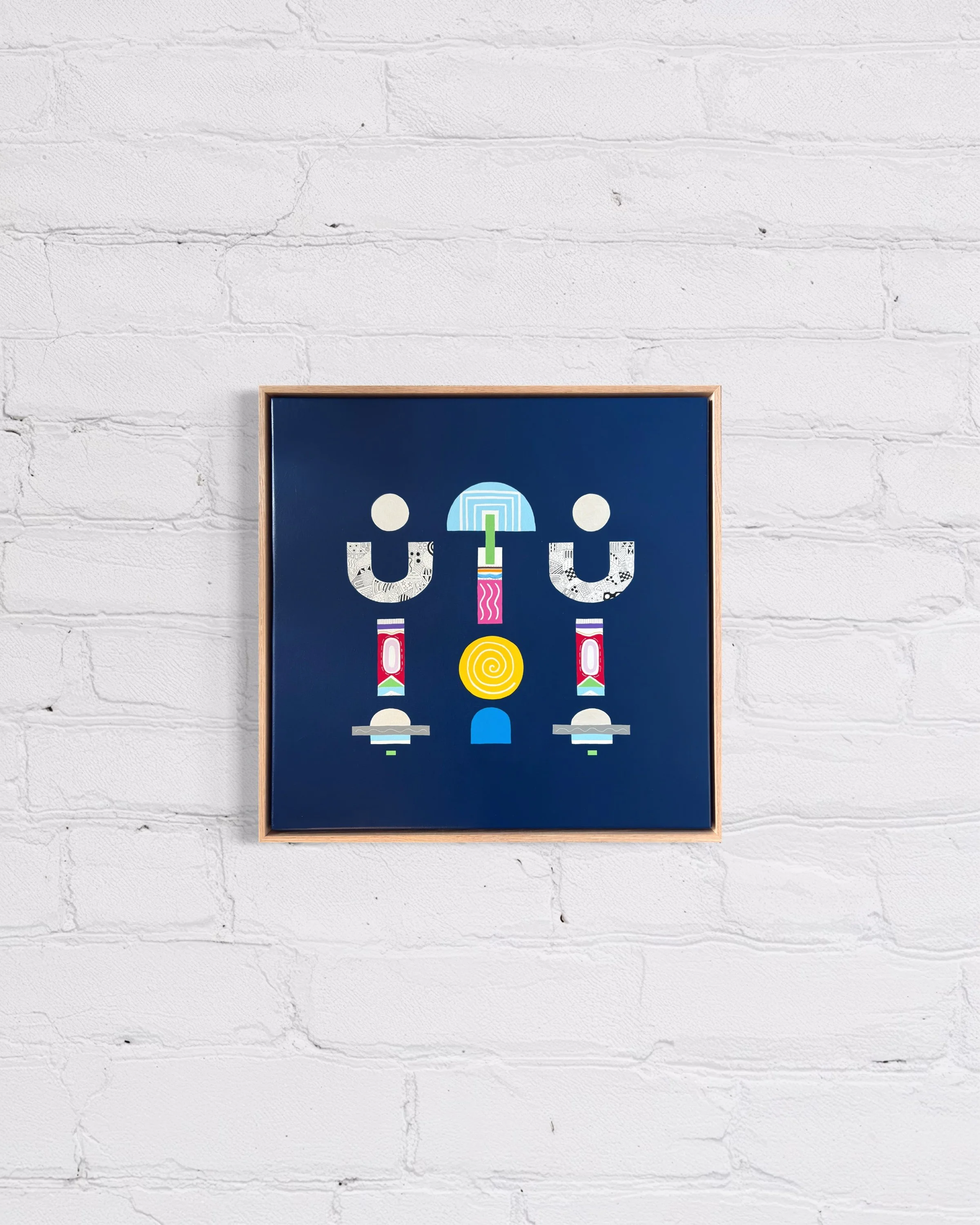 Upward Turn, original abstract artwork on canvas, geometric forms on a blue background, displayed on a white brick wall.