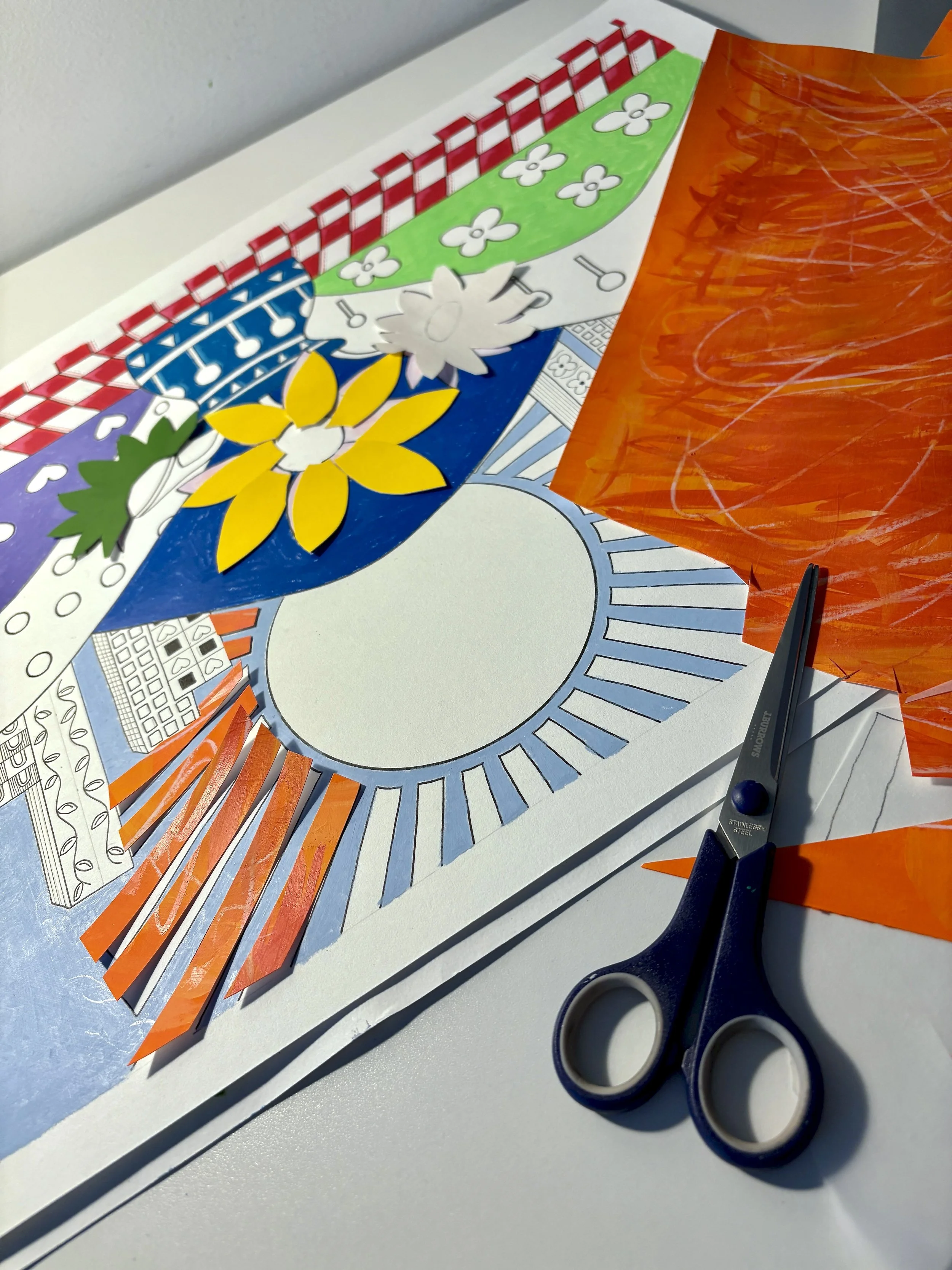 One of Sam Jackson's artworks in progress, with collage pieces and scissors.