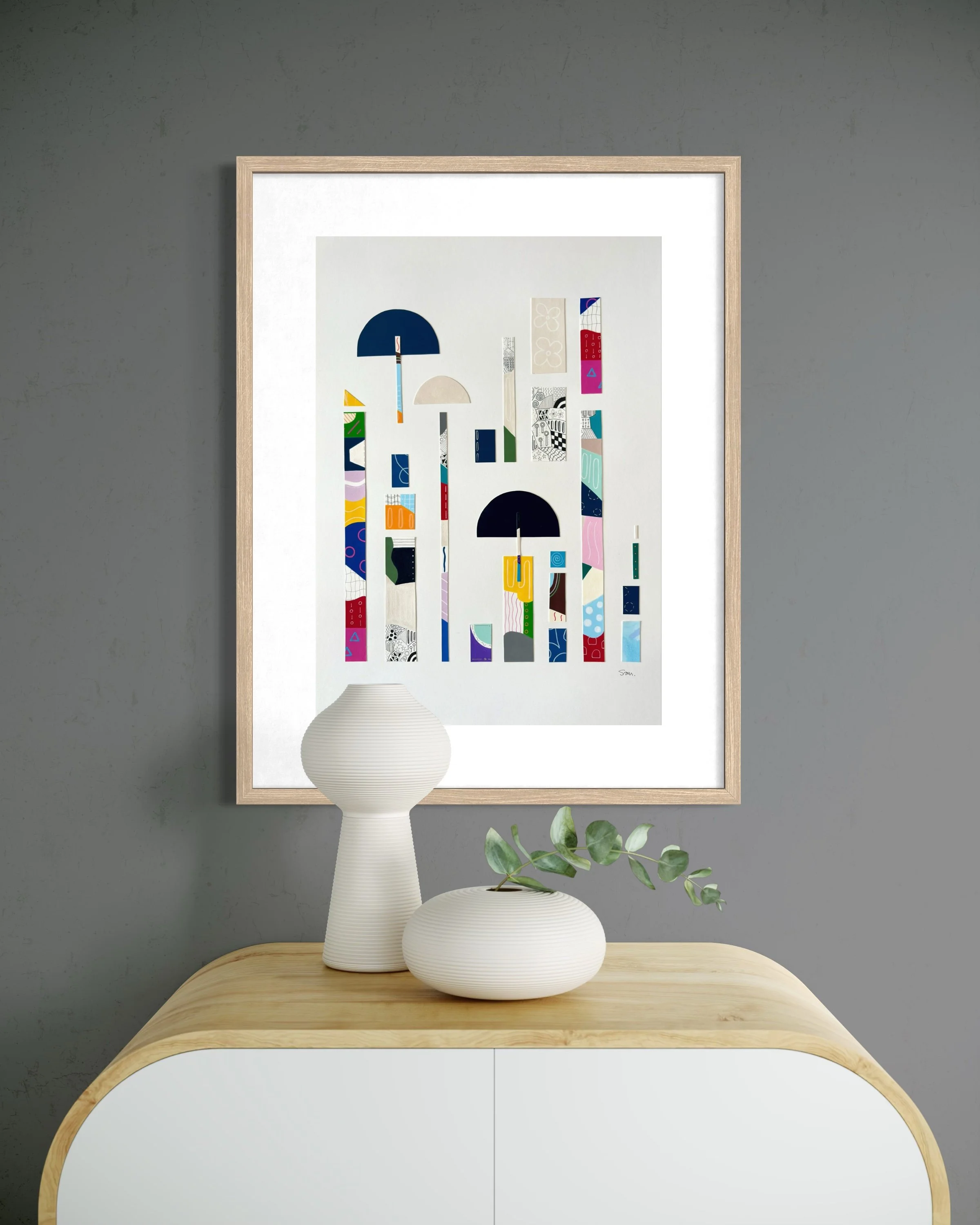 Between Play and Order, original mixed media on A2 paper with geometric and abstract forms, colour, pattern, and hand-drawn marks, styled in a modern interior.
