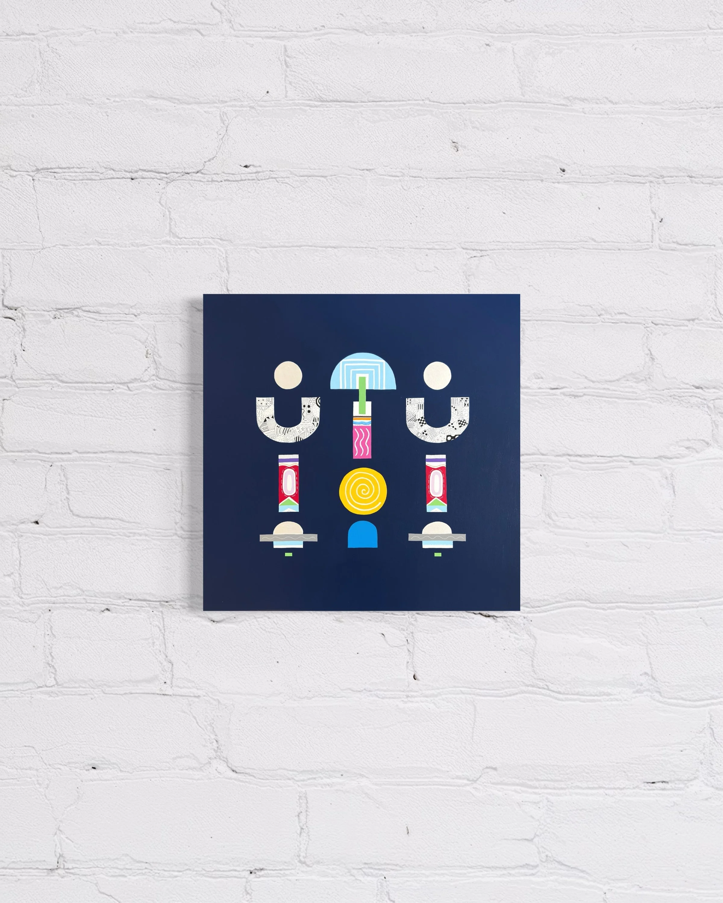 Upward Turn, original abstract artwork on canvas, geometric forms on a blue background, displayed on a white brick wall.