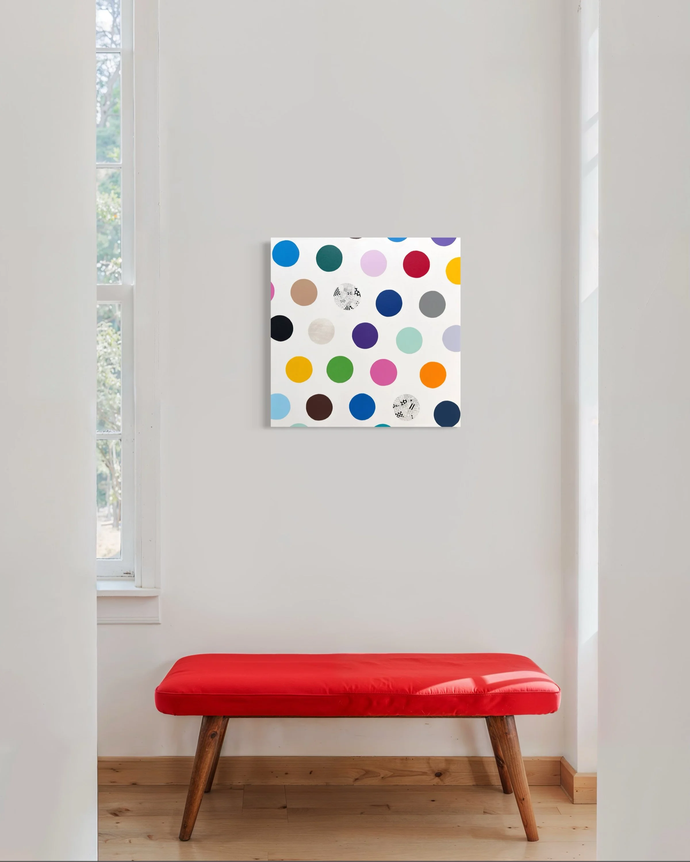 Spot The Happy Smile, original mixed media abstract on canvas with a white background and colourful spots, displayed in a modern hallway with a red bench seat.