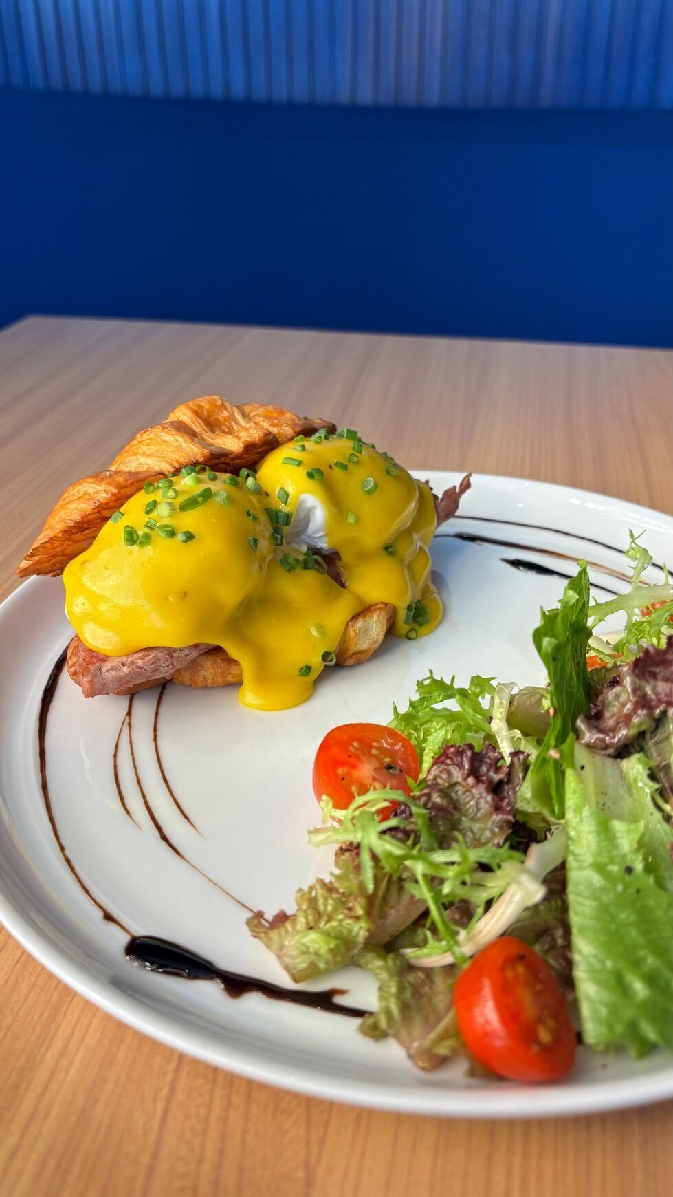 Eggs Benedict in Ubud Bali — poached eggs with beef ham and miso hollandaise on butter croissant at Studio Egg