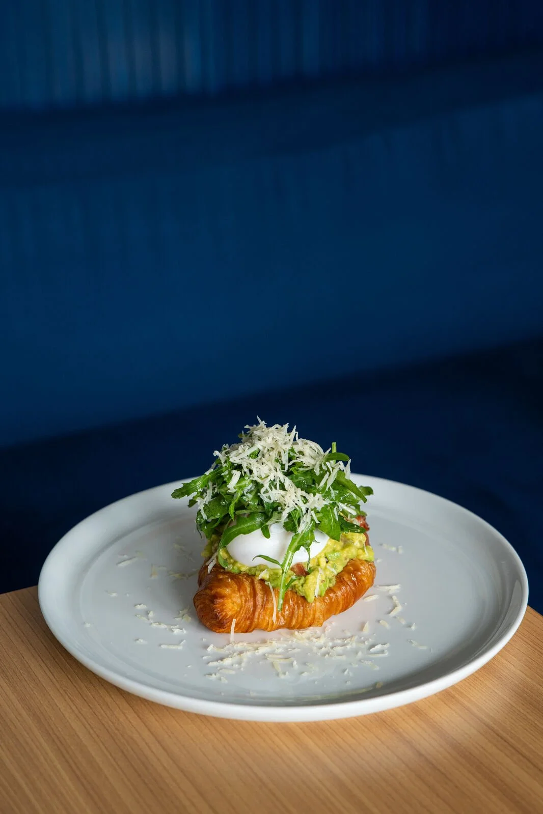 Avocado Croast with poached duck egg, guacamole, organic rucola and grated parmesan on butter croissant toast at Studio Egg cafe Ubud Bali