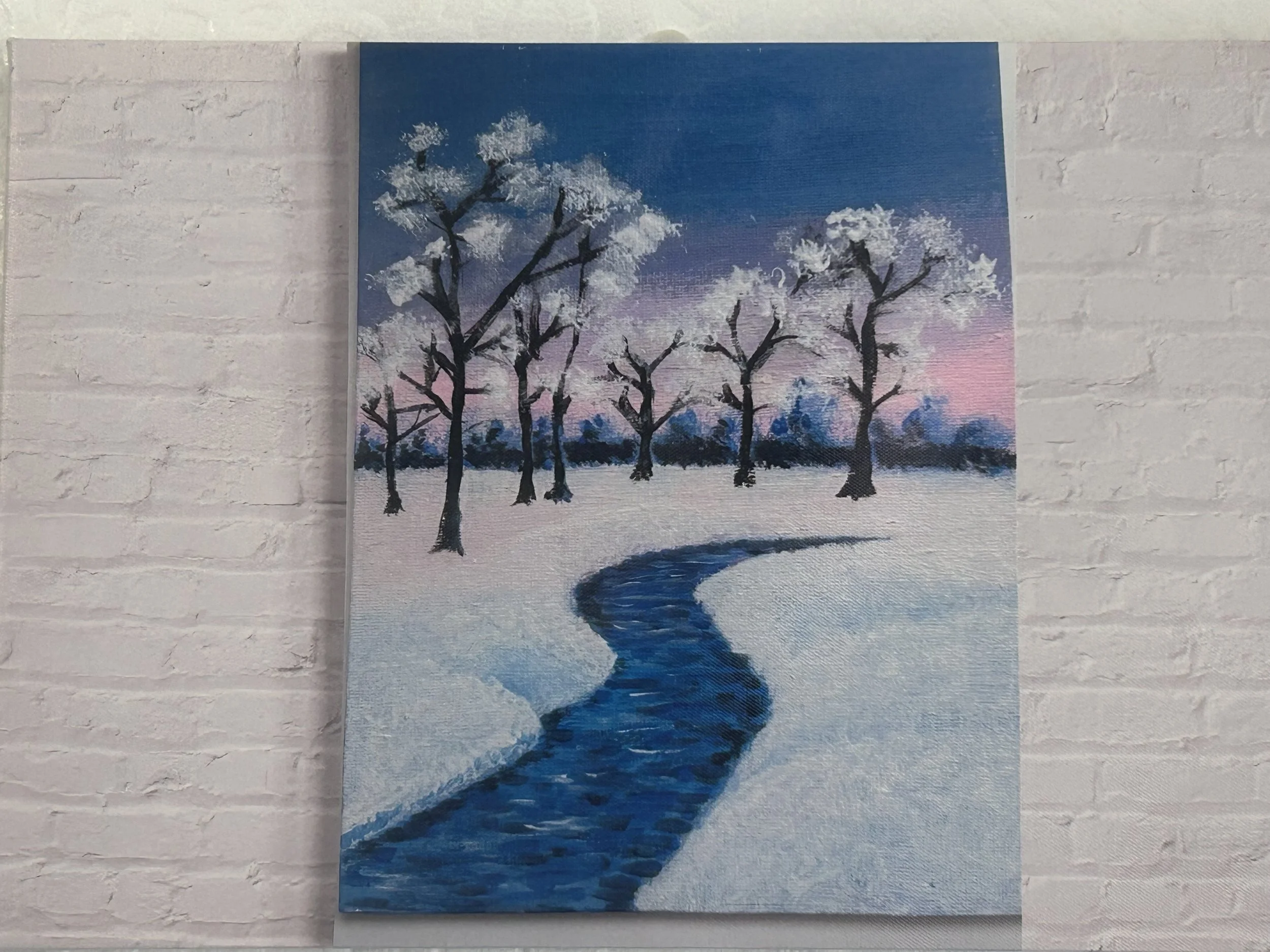 Painting of a winter landscape with snow-covered trees and a winding stream under a sunset sky.