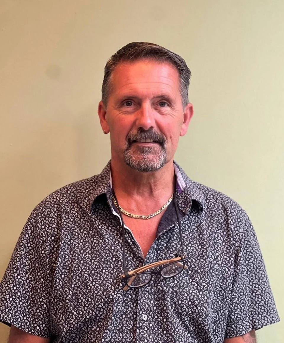 A generic illustration of a person with no facial features, gray hair, and gray clothing on a light background.