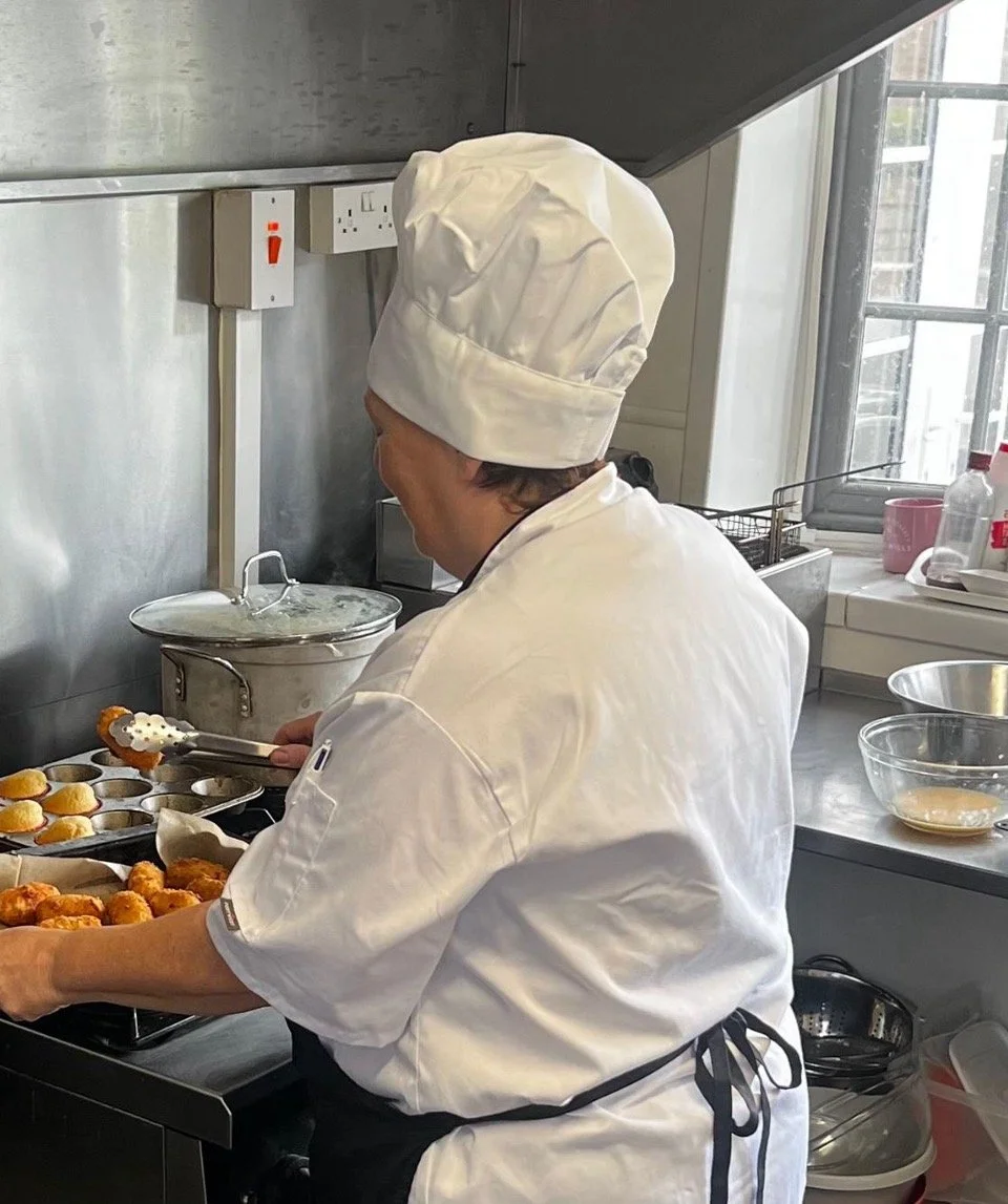 A simplified illustration of a woman with shoulder-length hair, no facial features, gray color on a light background.