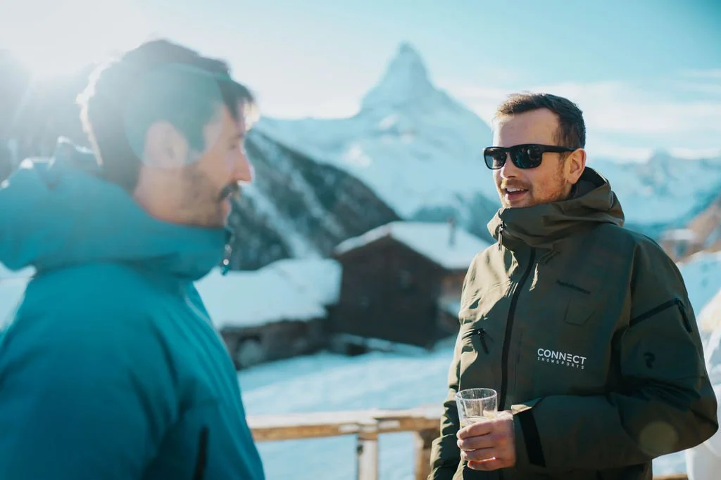 Connect Snowsports instructors sharing a relaxed moment between ski lessons in Zermatt