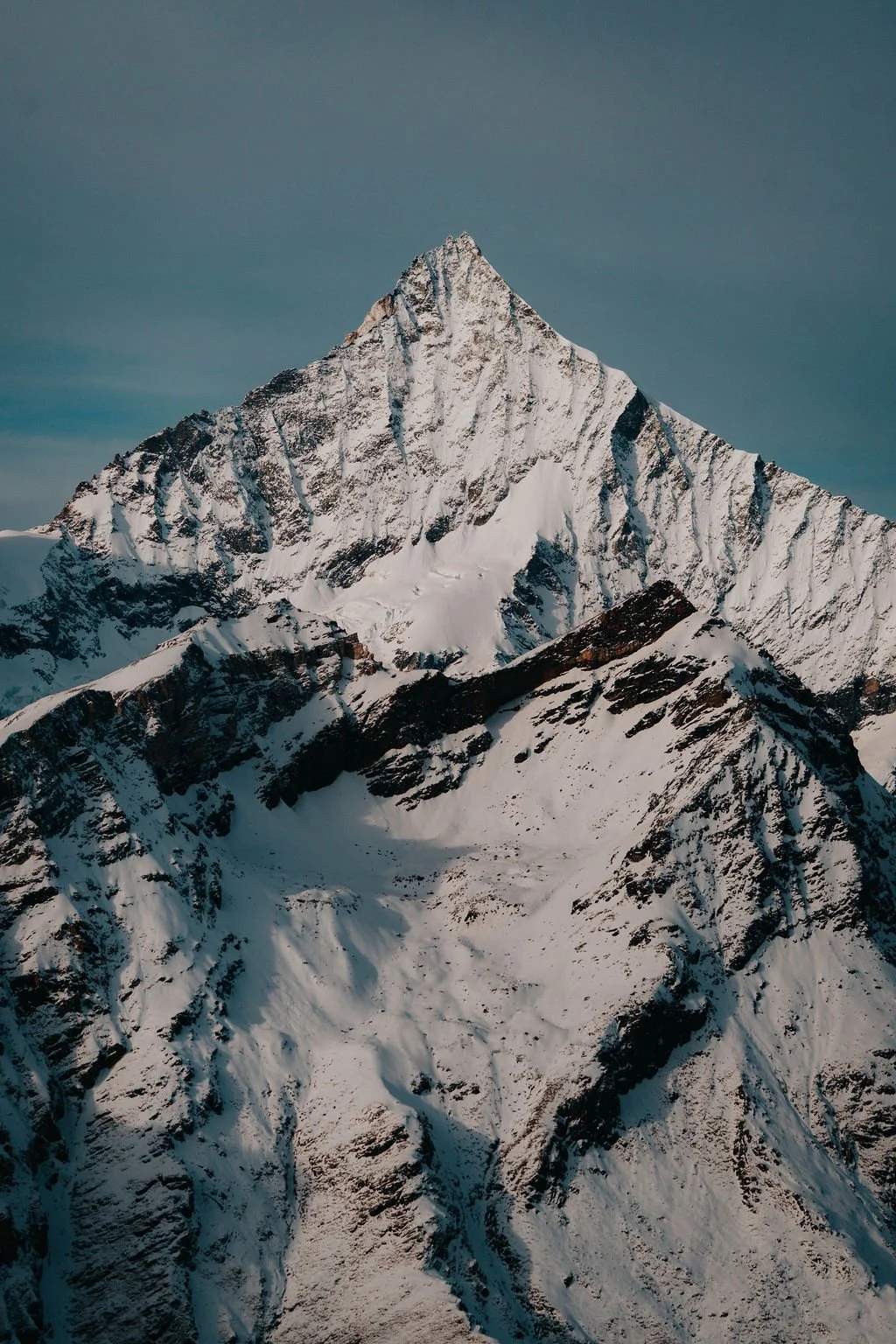 Off-piste ski lesson in Zermatt with instructor and client skiing controlled natural terrain