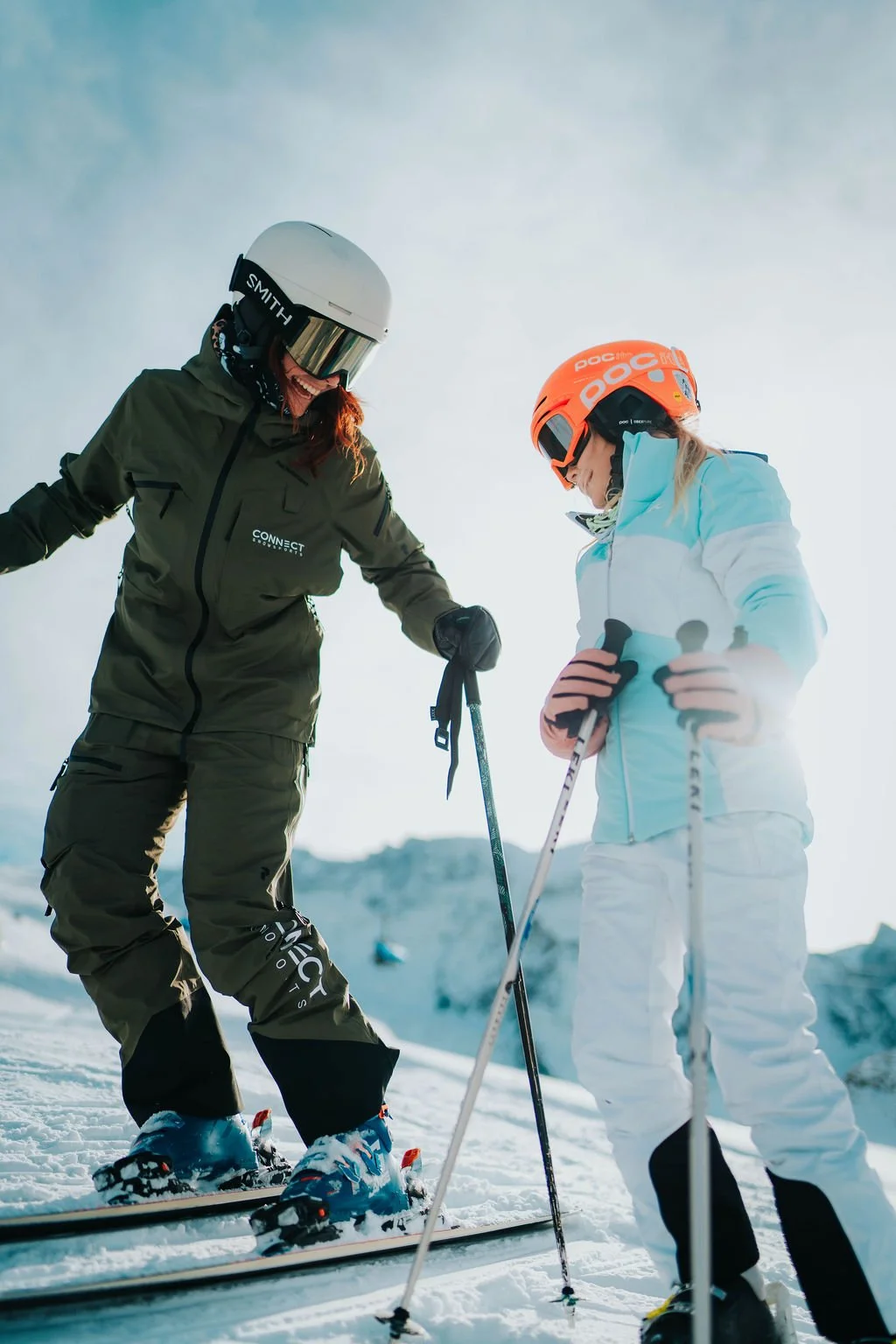 Ski instructor skis with 8 year old girl in kids ski groups