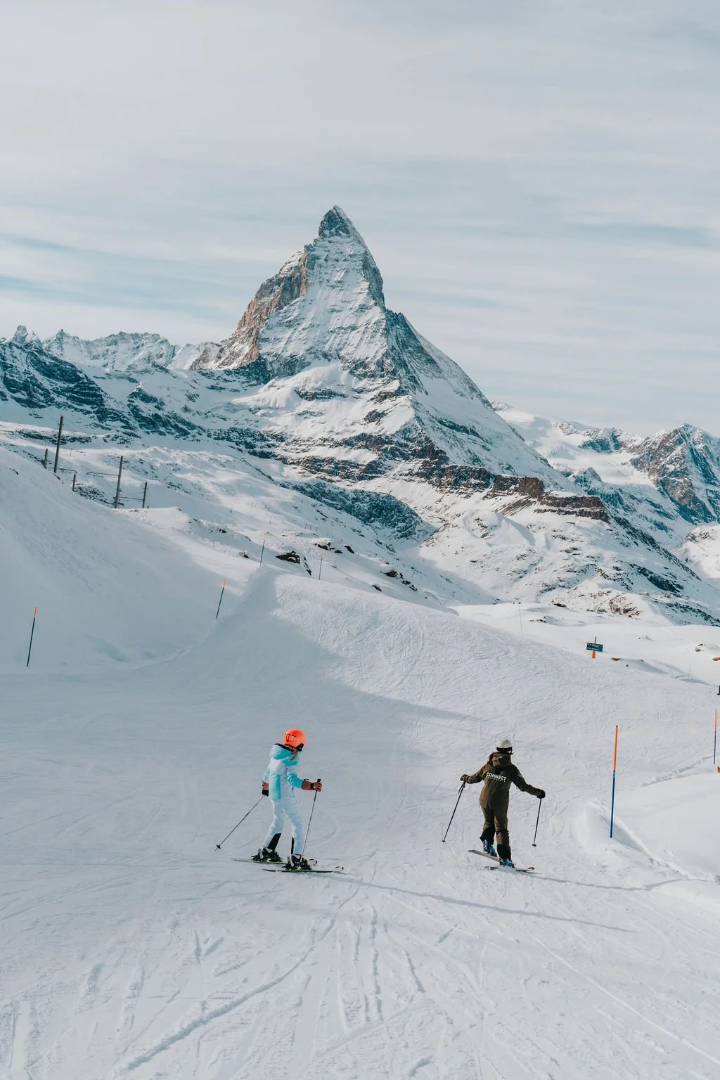 Ski instructor Helen and client ski together underneath the Matterhorn on Rifelberg