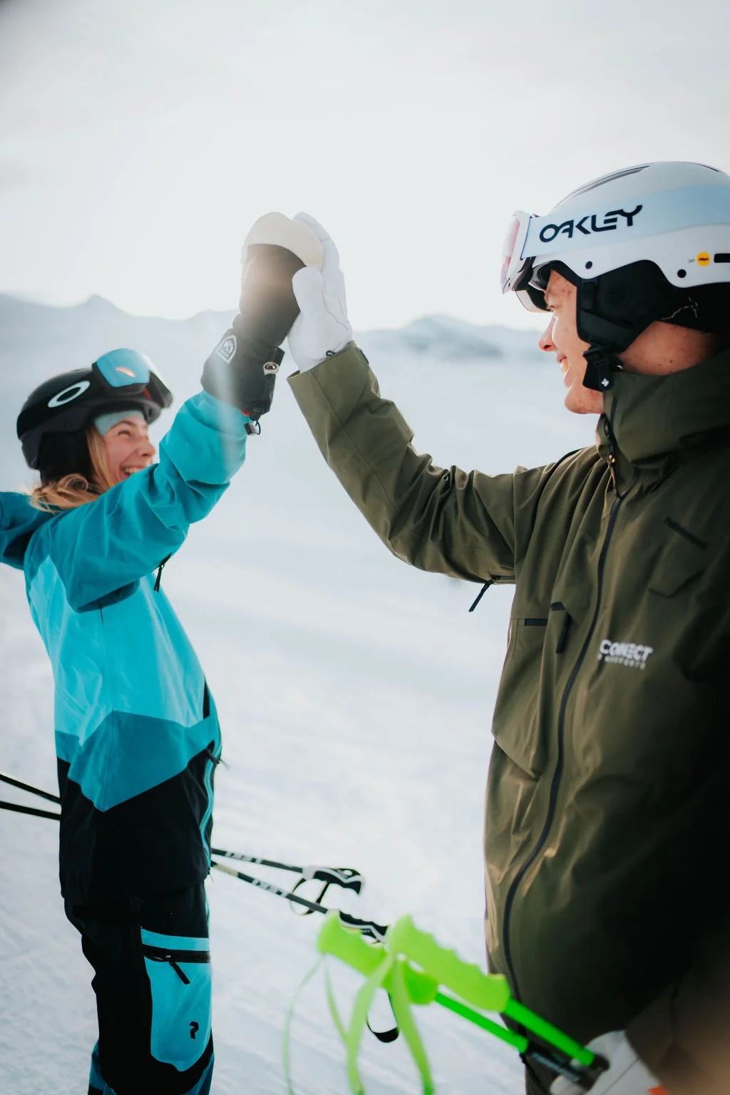 Ski instructor gives client a high five after a successful ski lesson in Zermatt