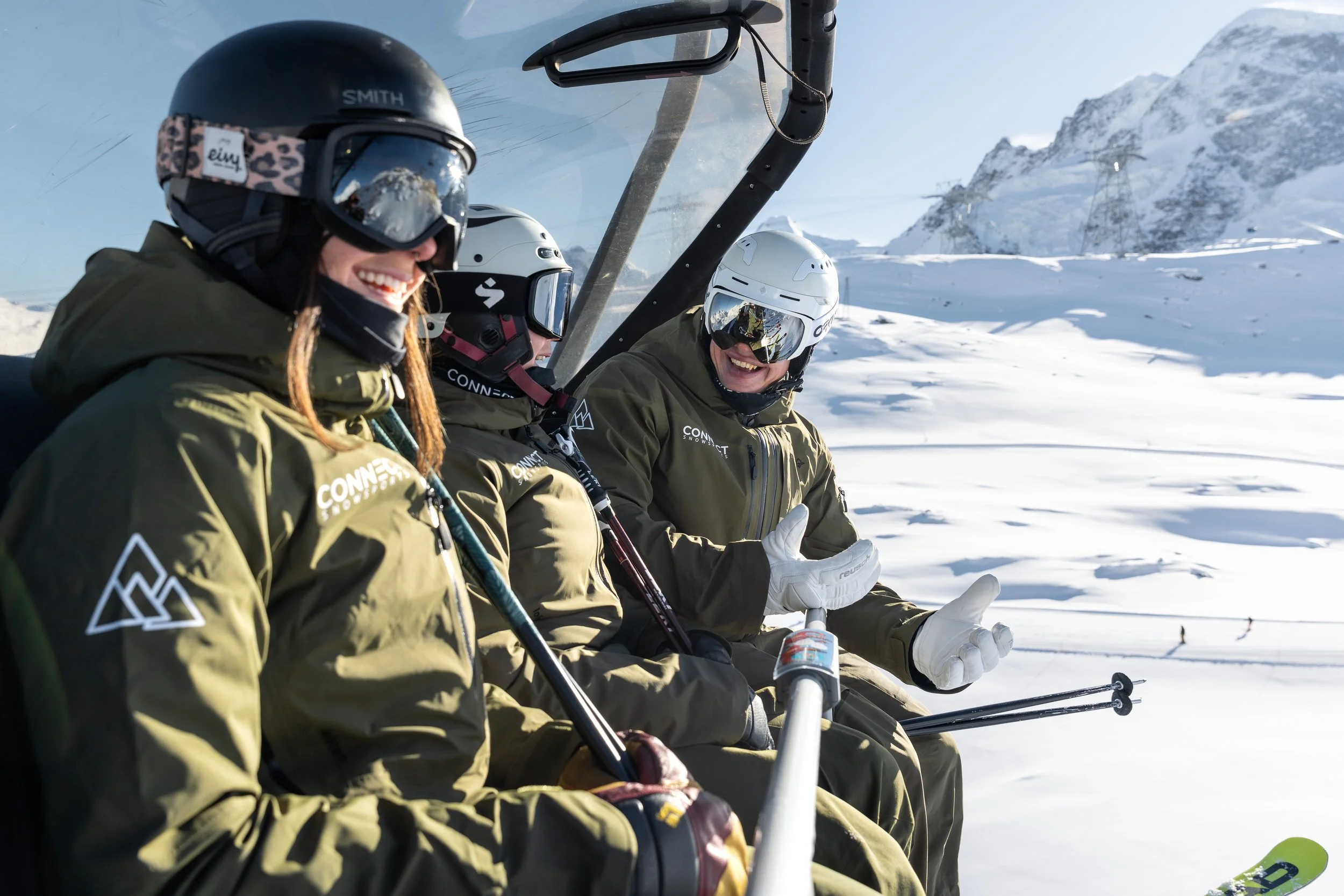 Ski instructors on a chairlift together in Zermatt, Switzerland
