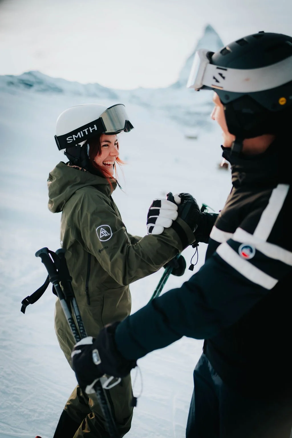 Ski instructor Helen and client high fiving at the end of a lesson in Zermatt