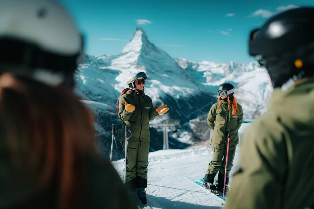 Connect Snowsports instructors sharing a training moment between ski lessons in Zermatt