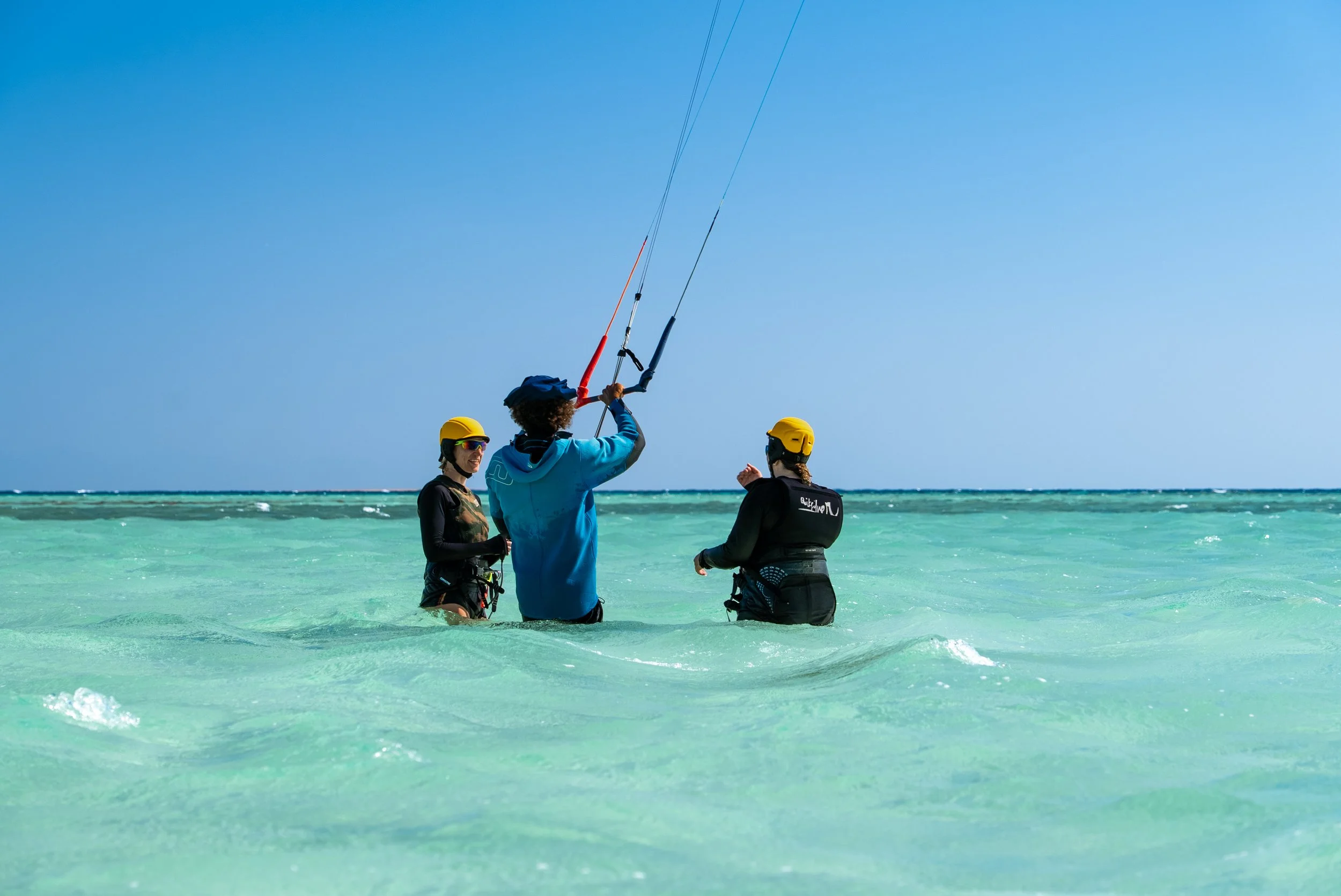 Kite Instructor teaching two kitesurf students during the kite safari