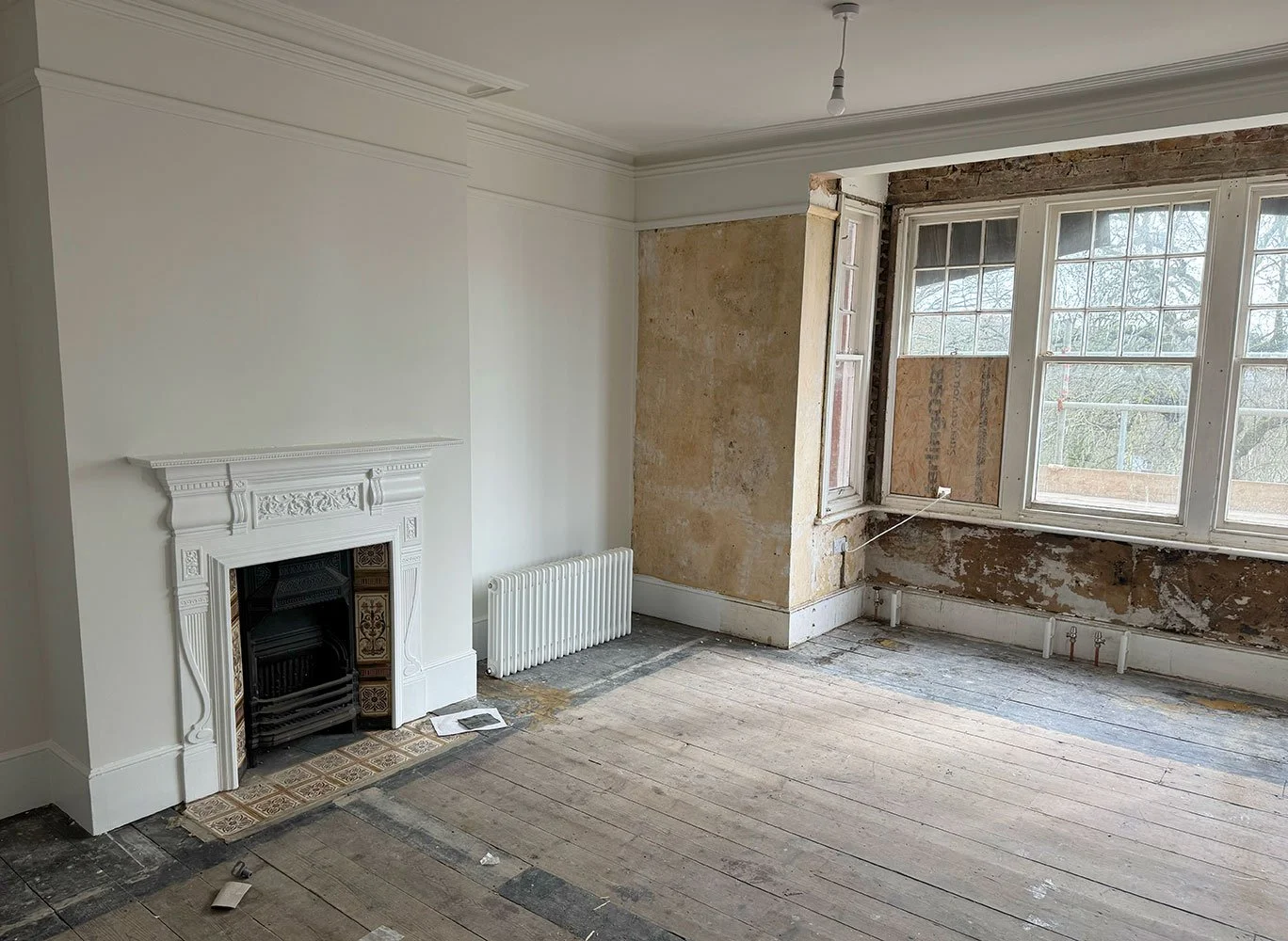 Front reception room stripped back during refurbishment at West Drive property