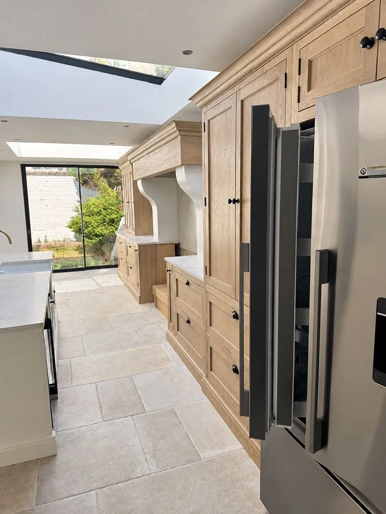 Oak kitchen cabinetry and integrated appliances in the completed West Drive renovation