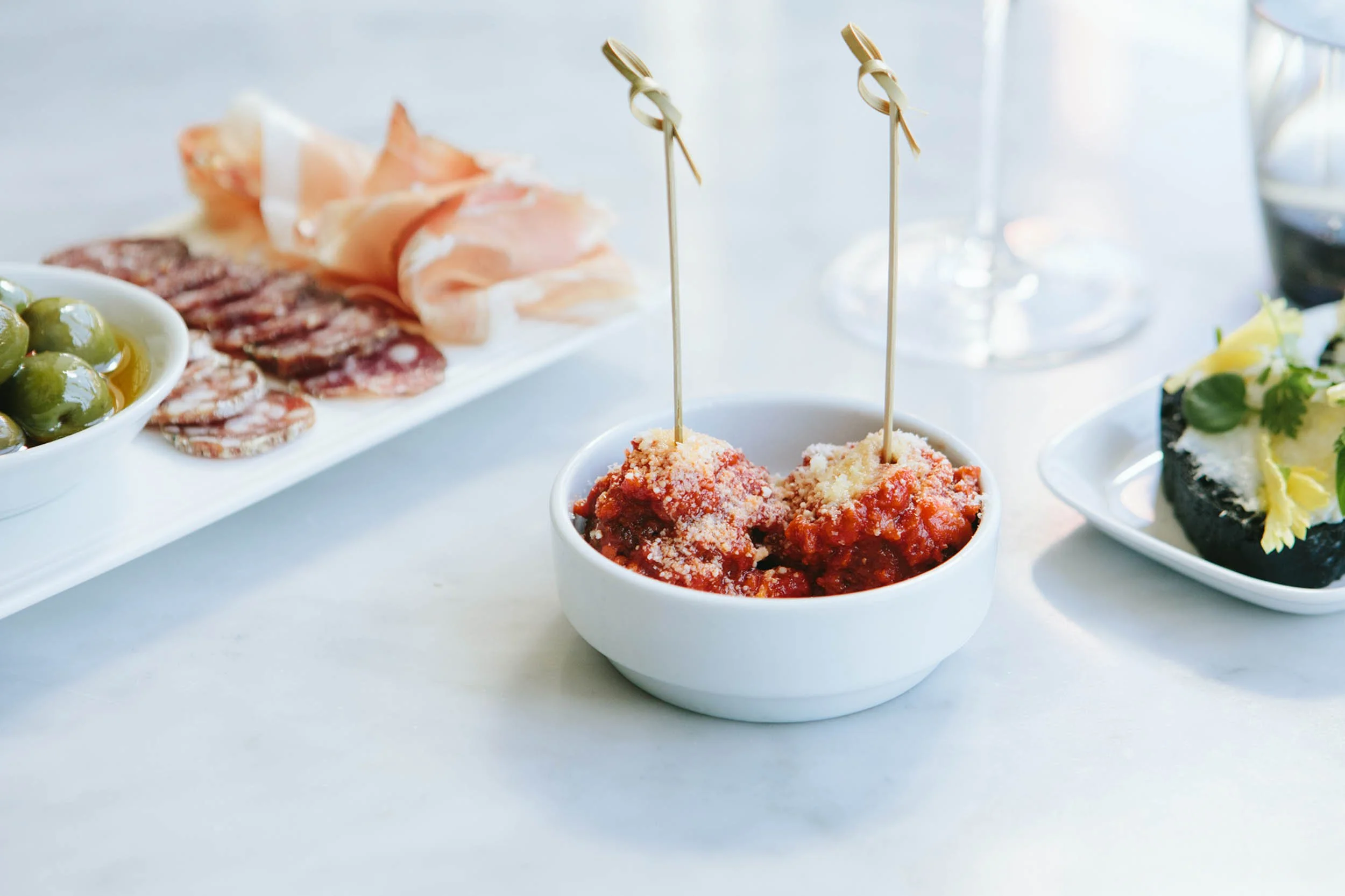 Appetizer spread featuring meatballs in center SRV Boston