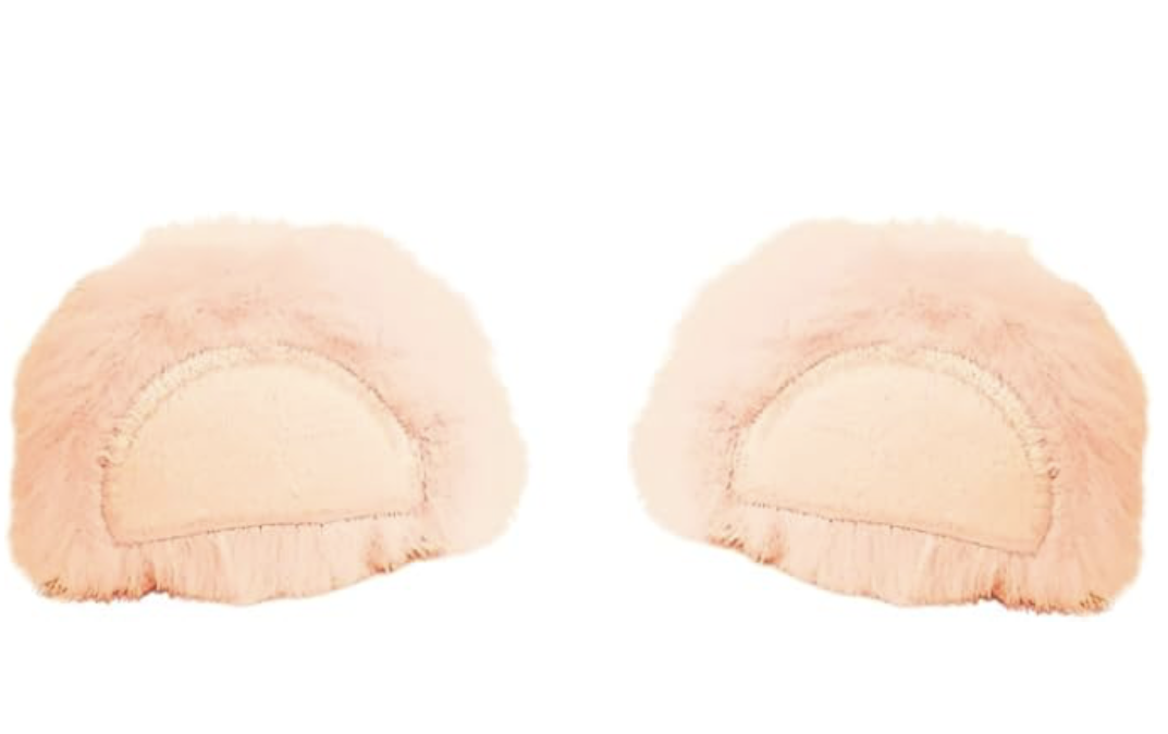 Two fuzzy pink slippers with a semicircular design on the top, positioned facing each other against a white background.