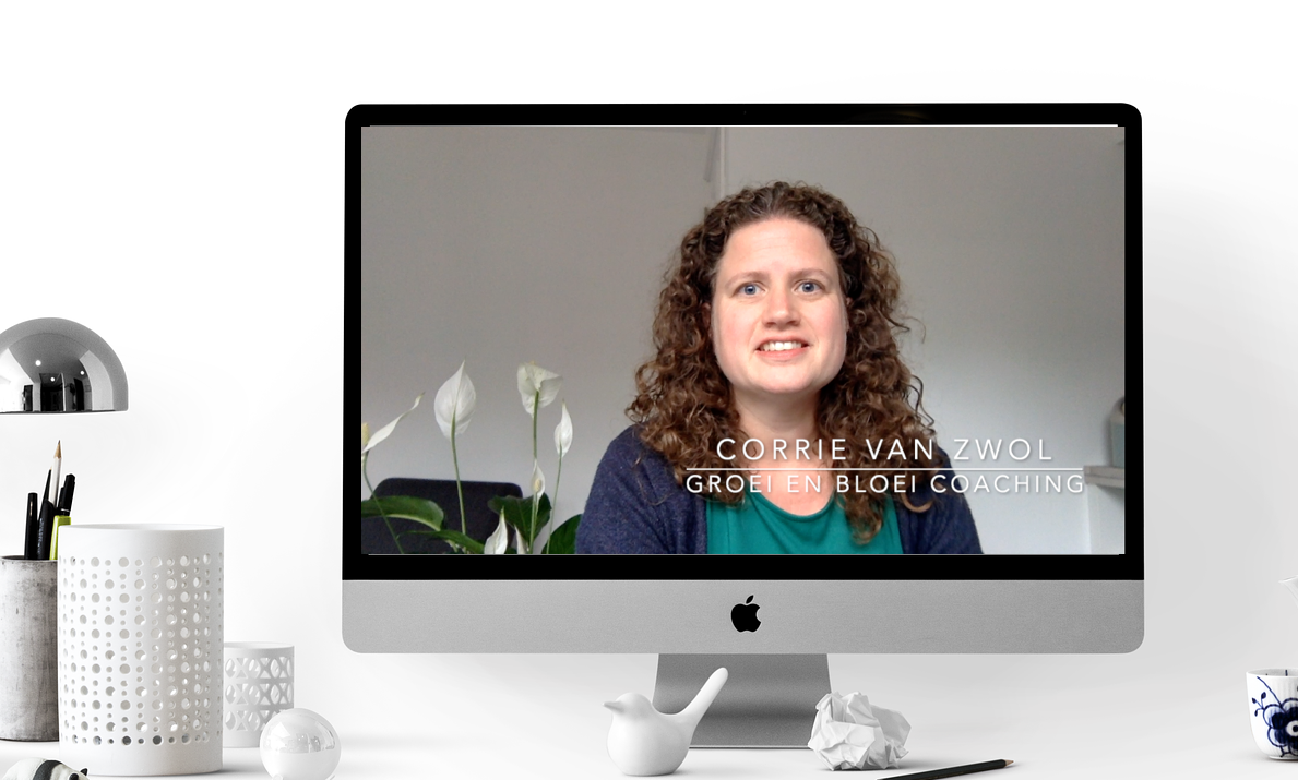 Computer screen displaying a woman with curly brown hair in front of a plant, with text overlay that reads 'Corrie Van Zwol Groei en Bloei Coaching'.