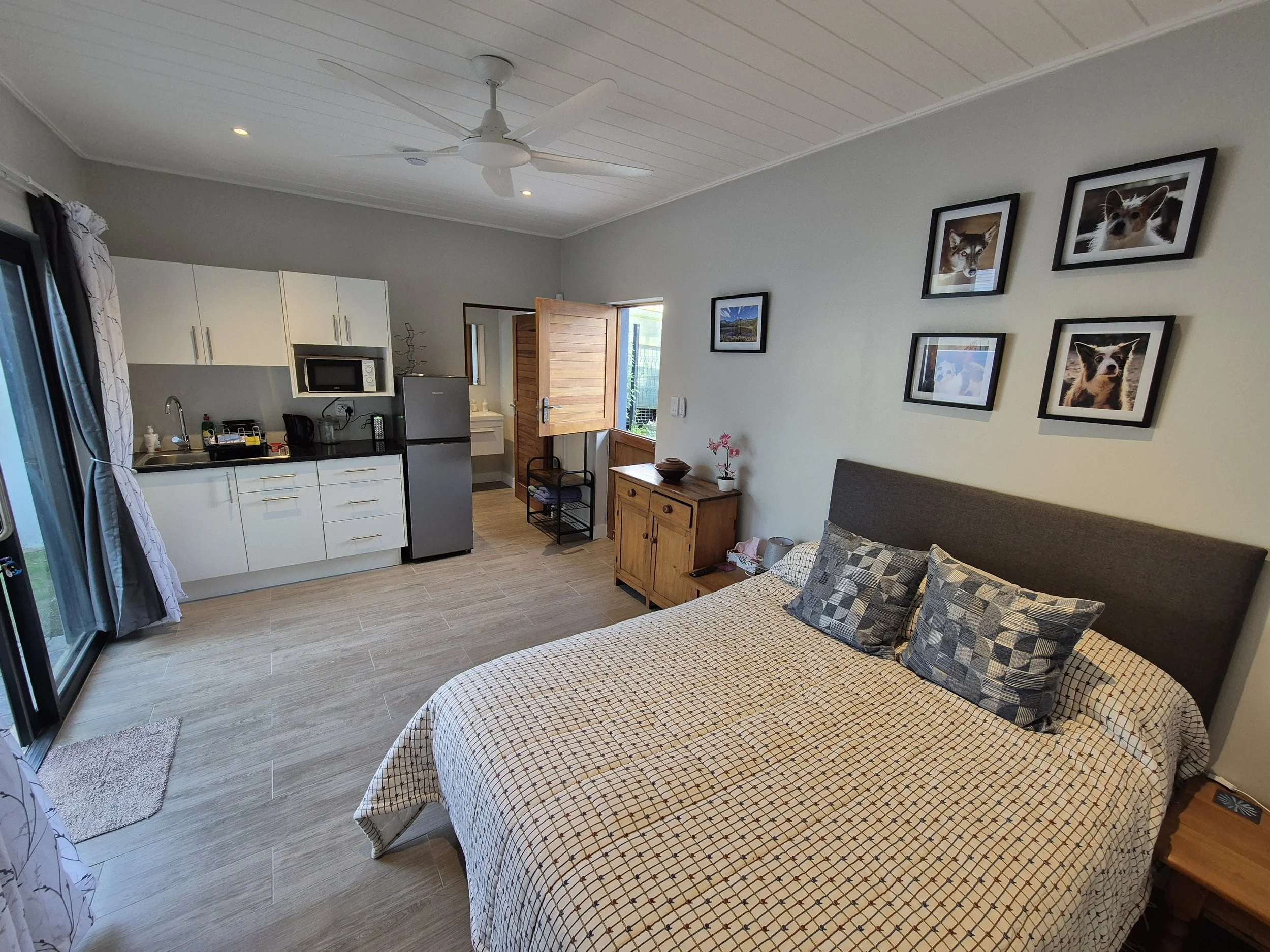 View from the far side of the room towards the front door and kitchenette