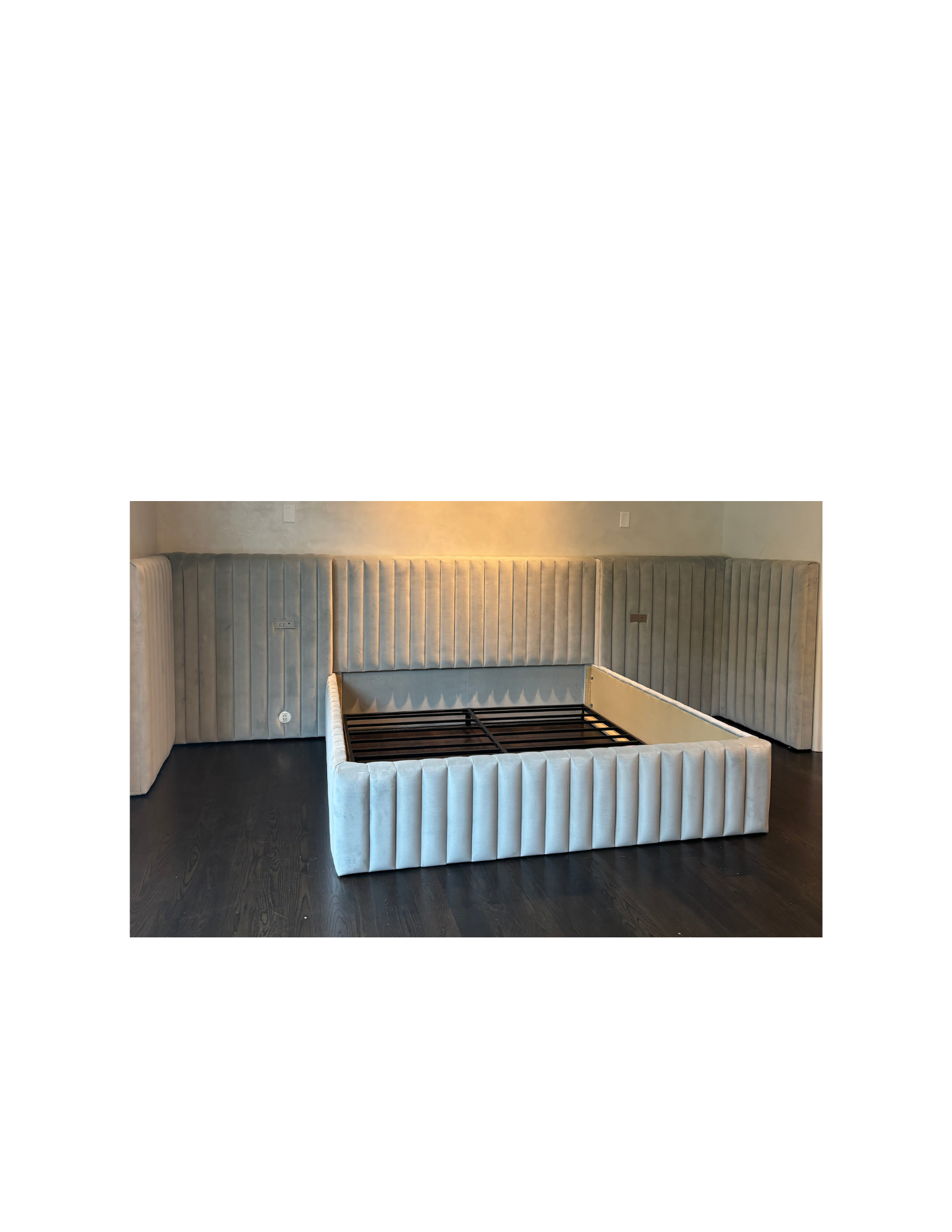 Custom upholstered bed frame and integrated headboard fabricated and installed by Patrona Design Studio, featuring vertically channeled upholstery built from designer specifications.