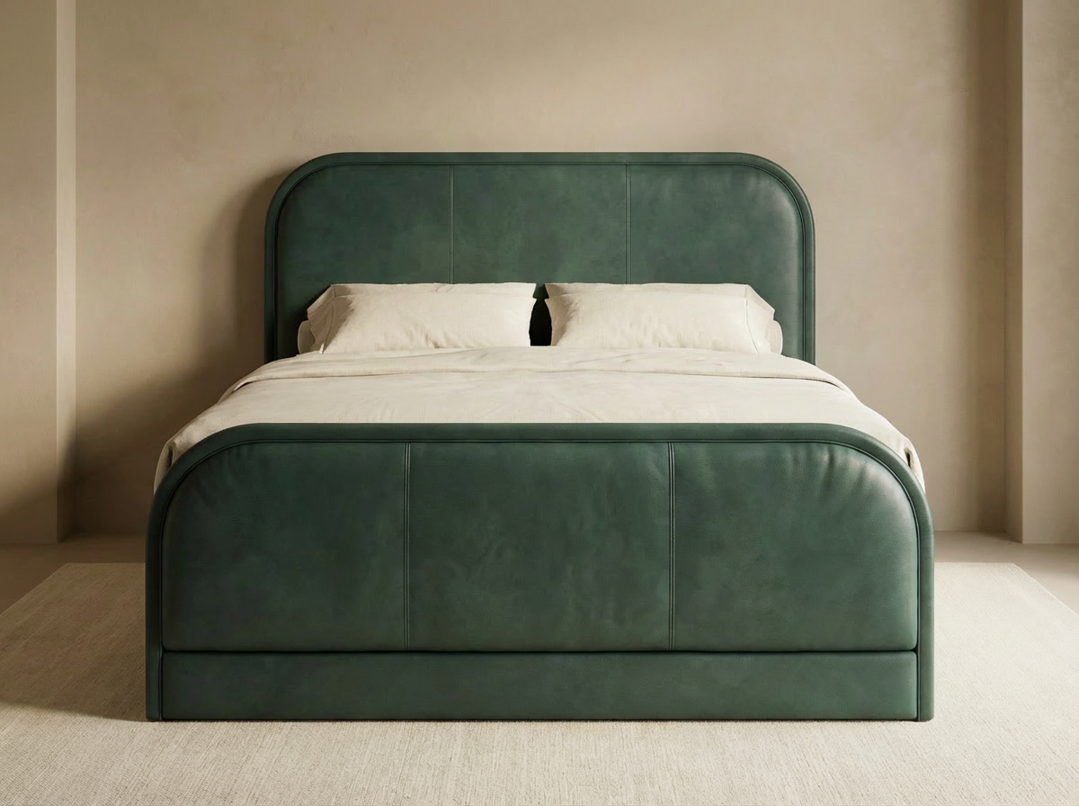 Custom upholstered bed in green leather with rounded headboard and integrated frame by Patrona Studio