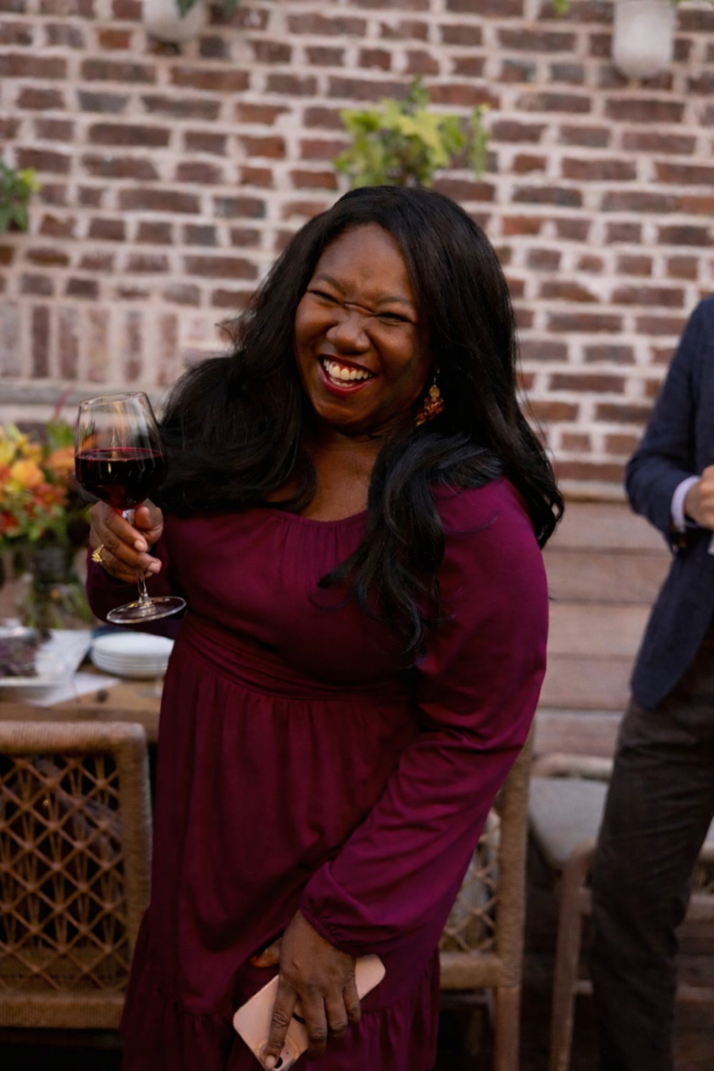Woman laughing as she holds a glass of the Limited Edition MianU Syrah