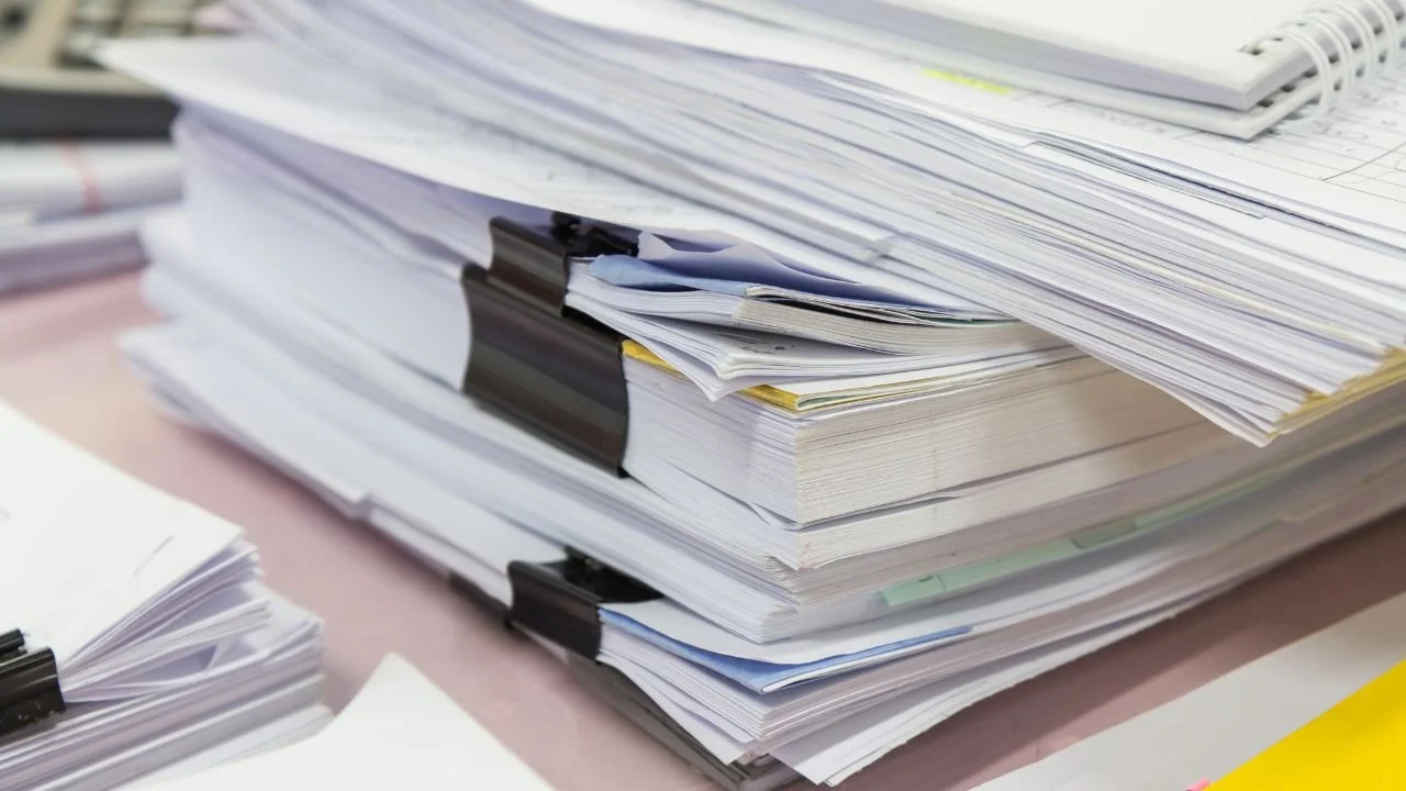 Stack of legal documents representing a civil lawsuit in debt collection