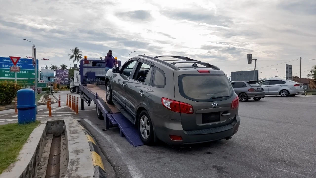 Vehicle being loaded onto a tow truck during a car repossession