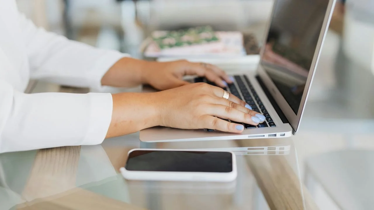 Person drafting a written dispute on a laptop to correct background check information