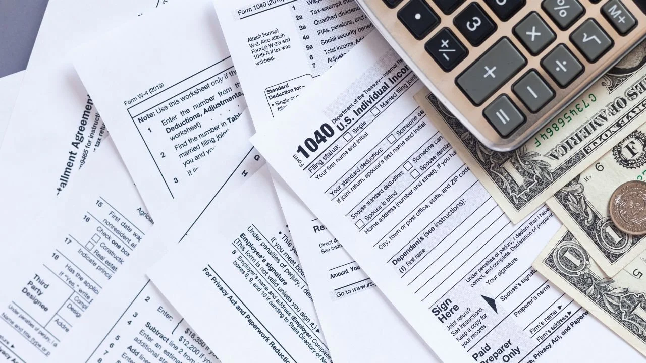 Tax forms and documents representing 1099 tax reporting threats by debt collectors