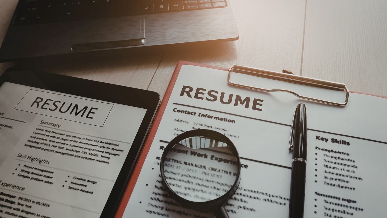 Resume and documents under review, representing employment background checks