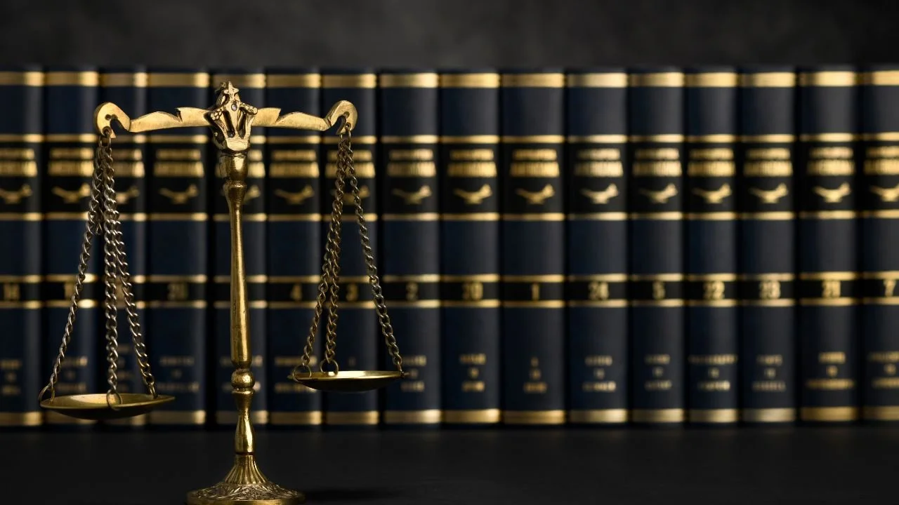 Scales of justice in front of law books representing consumer rights under federal law