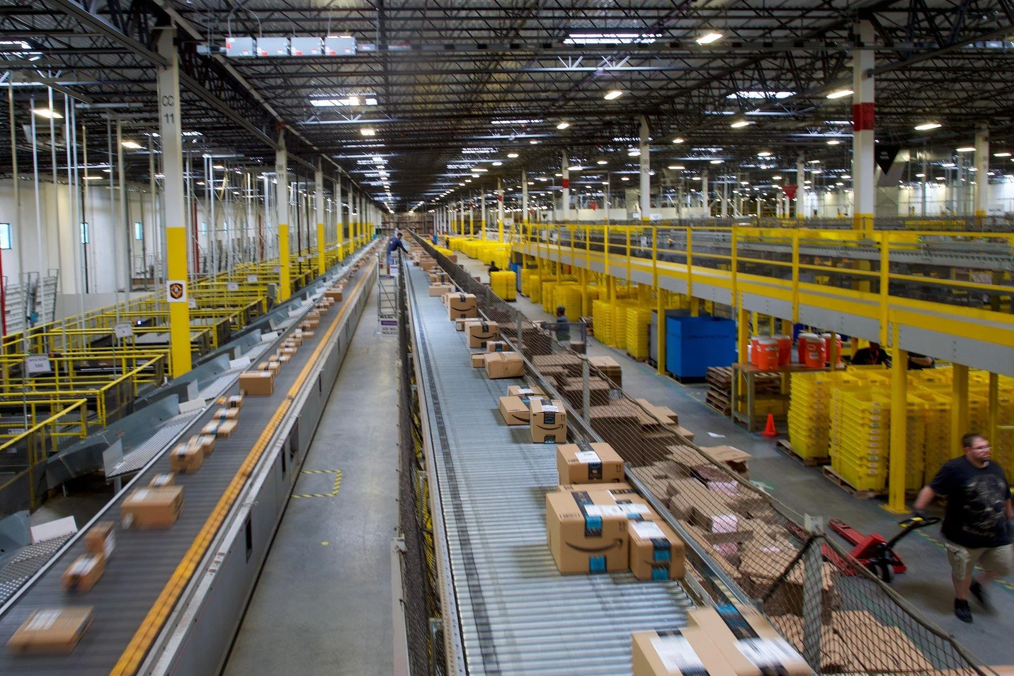 Amazon warehouse with packages on conveyor belts during fulfillment process