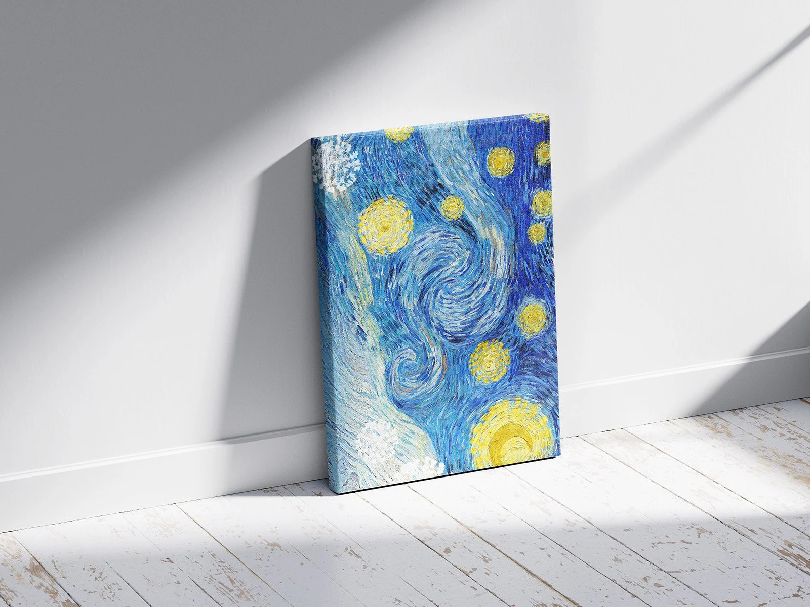 A canvas painting of Vincent van Gogh's "Starry Night" leaning against a white wall in a room with white wooden floor.