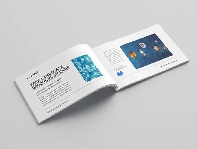 An open brochure on a light gray surface, displaying pages with water-themed images and text related to landscape brochure mockup.