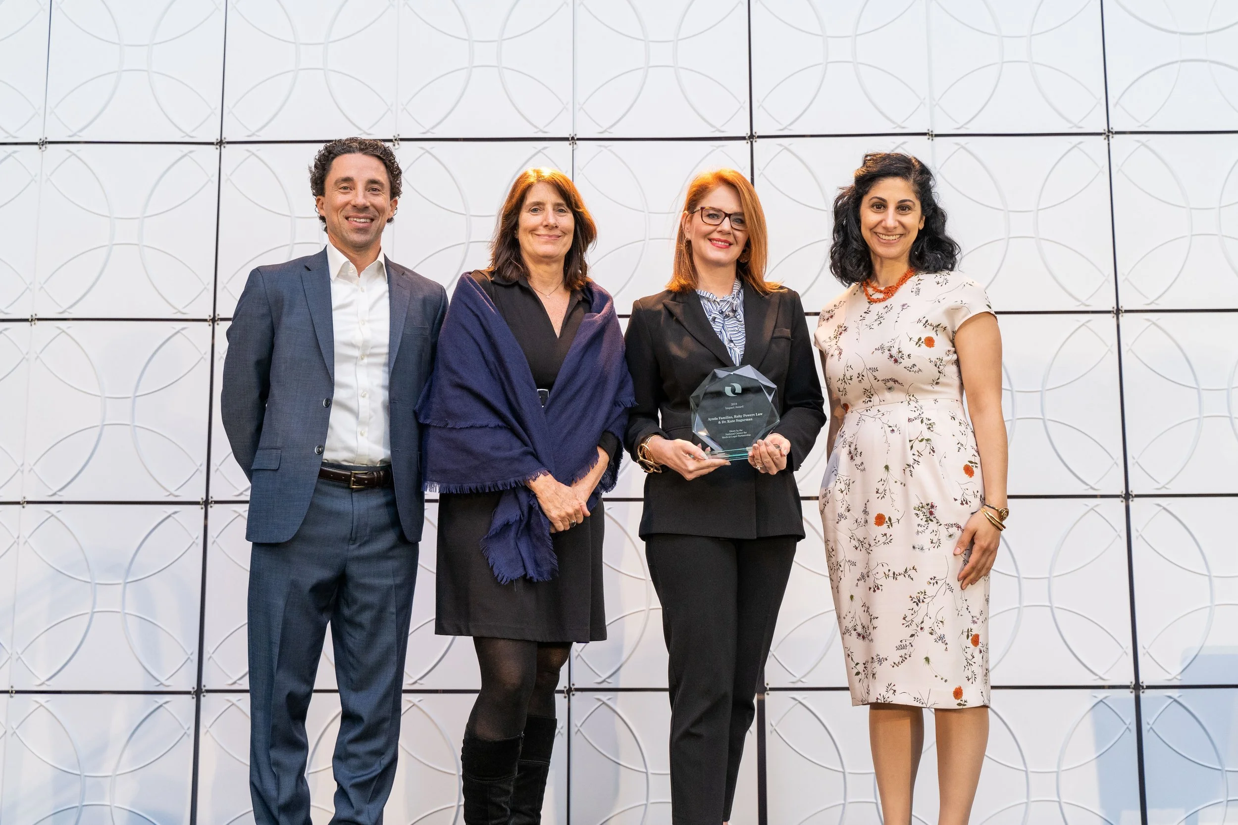 Ayuda Familias team accepting a 2019 MLP Award