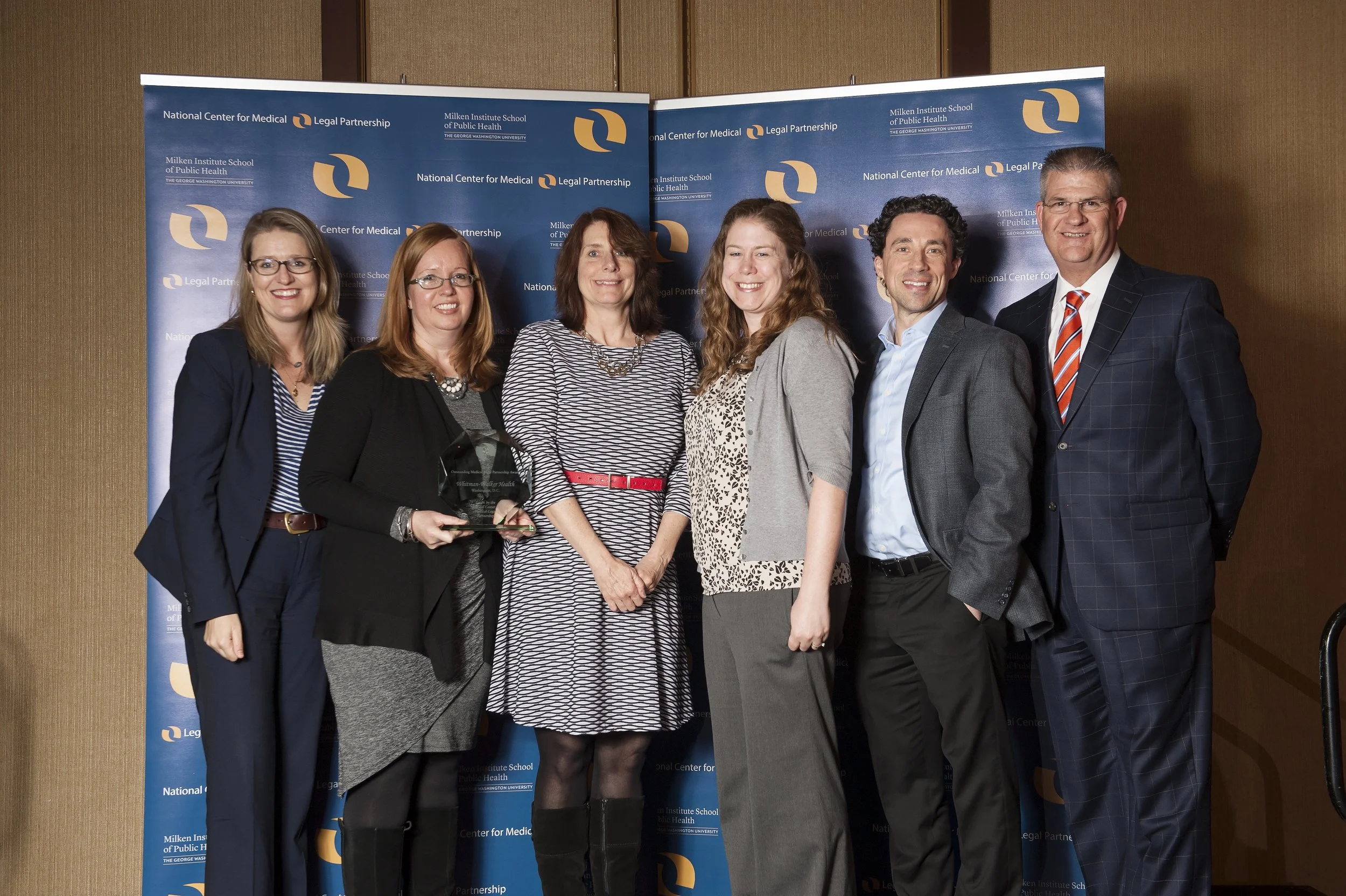 Erin Loubier (second from left) and Megan Coleman (fourth from left) accepting the 2016 Outstanding MLP Award on behalf of Whitman-Walker Health.