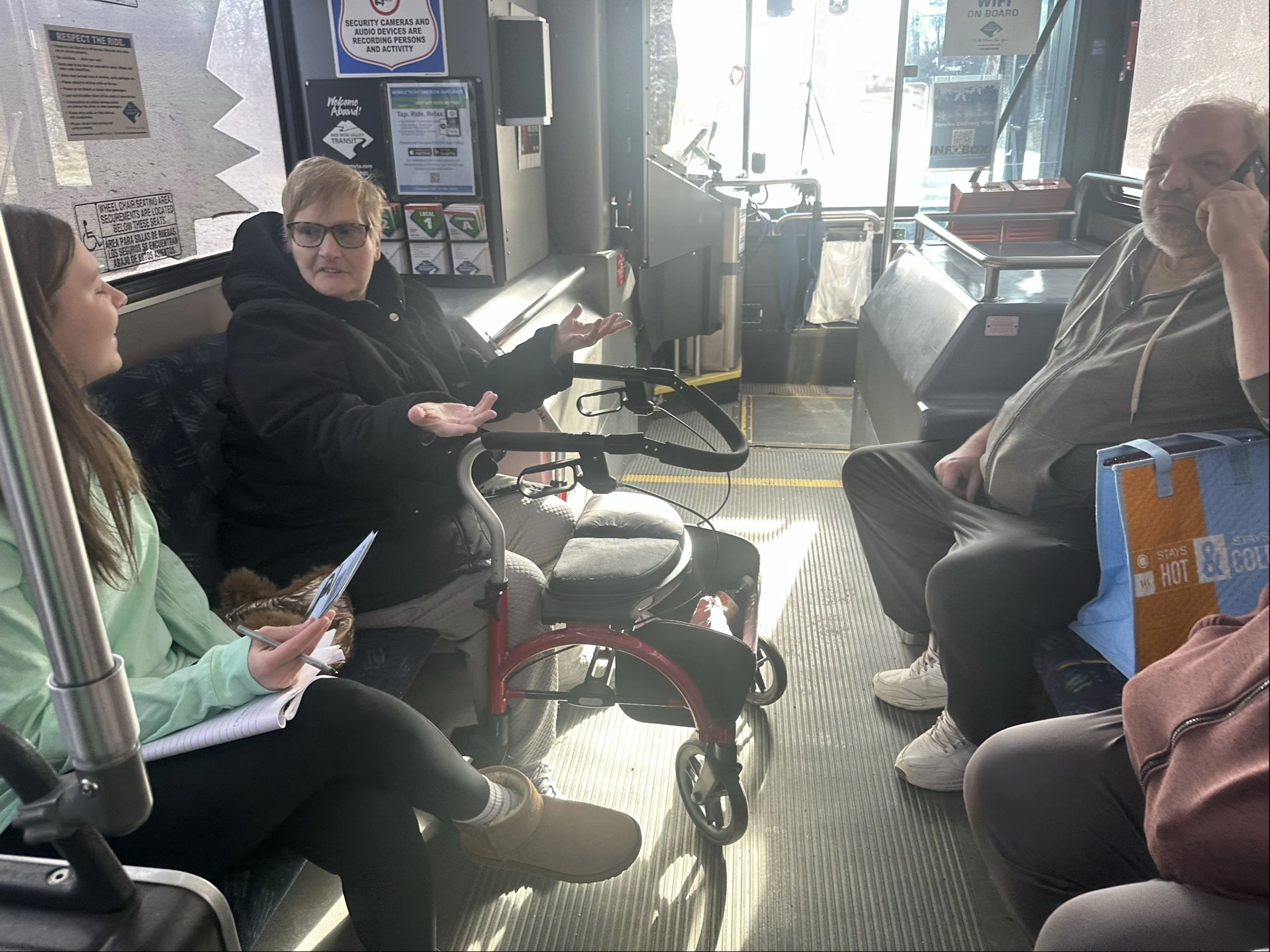 A Mid Mon Moves project team member interviews riders on an MMVTA bus.