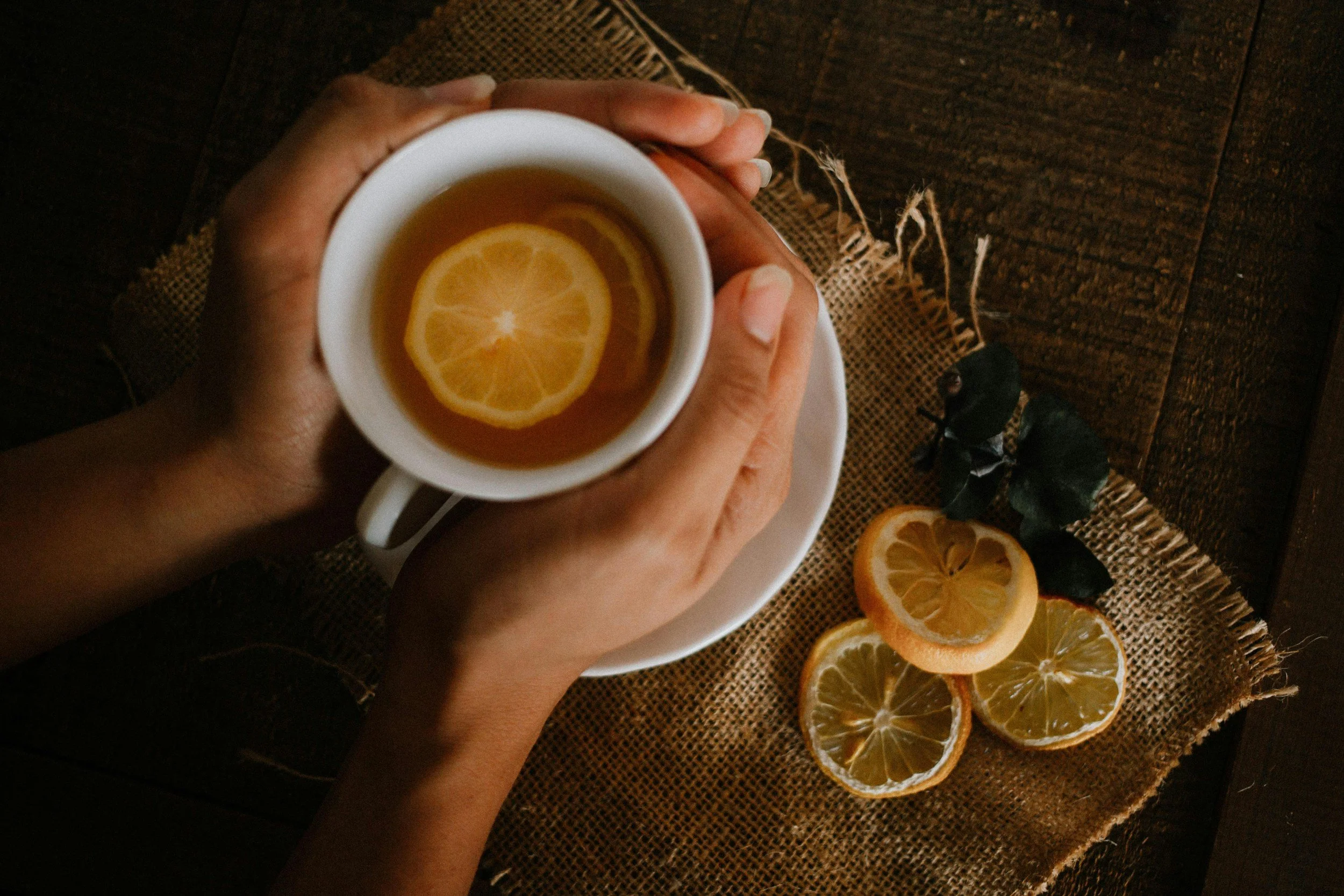 Hands holding herbal tea representing traditional healing practices, self-care, and cultural wisdom