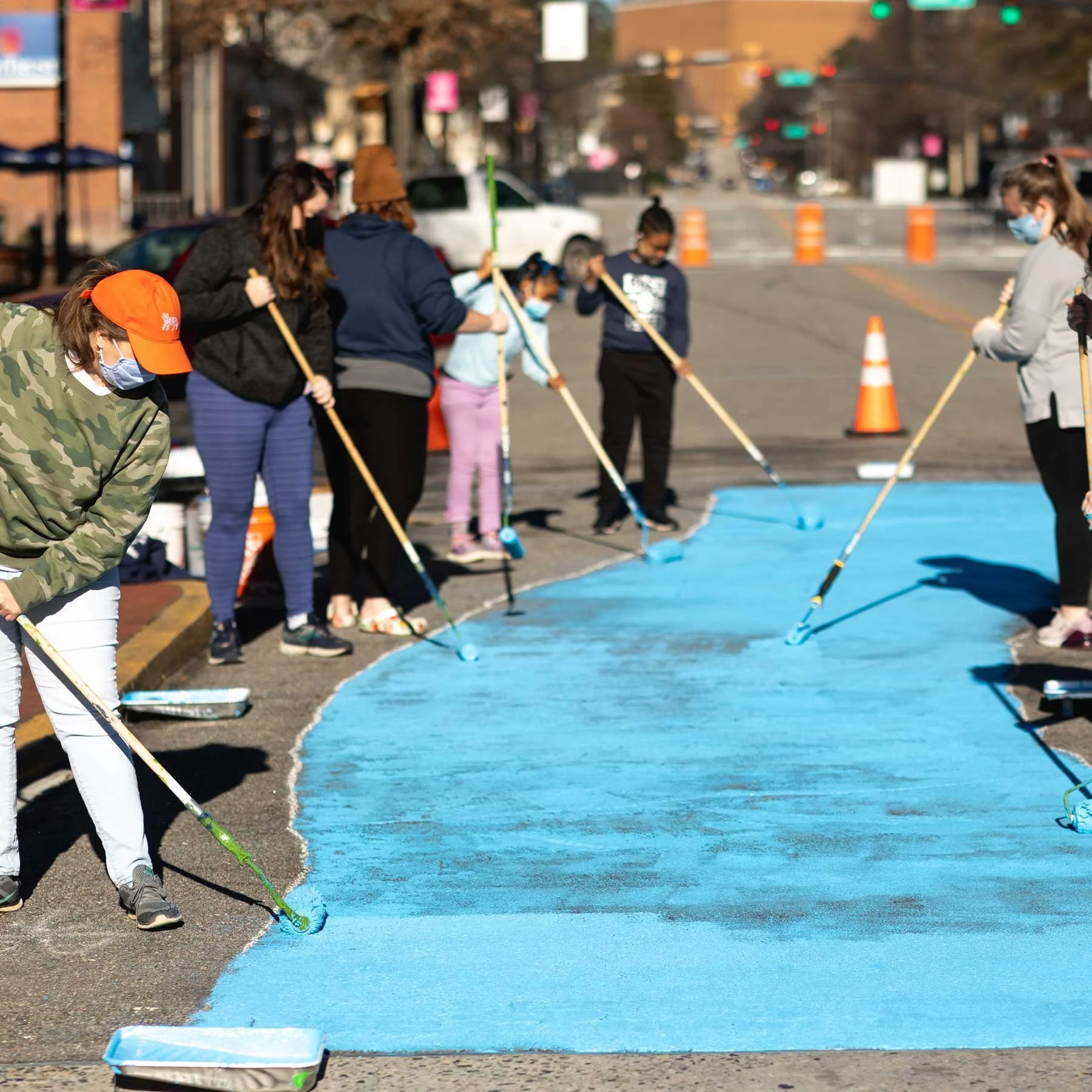 Volunteers begin the Cherry Street mural.