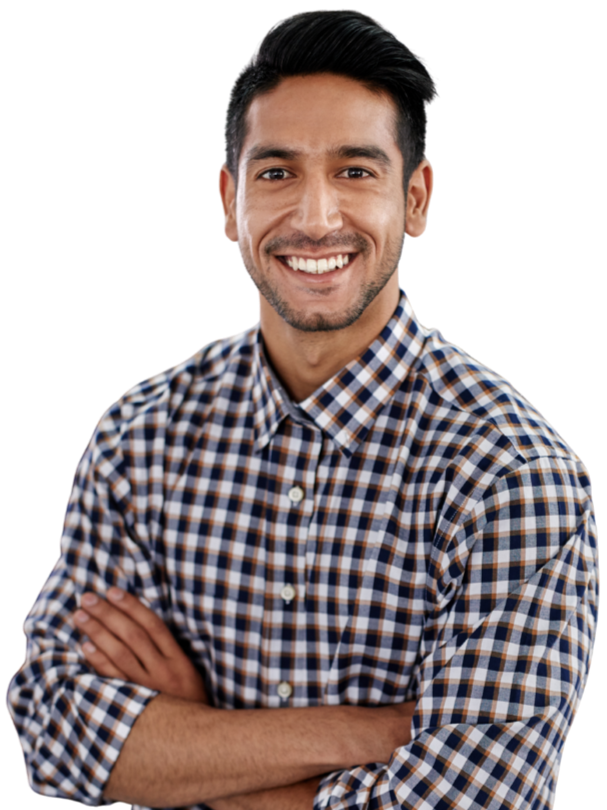 A smiling man with dark hair and a beard, wearing a checked shirt, standing with arms crossed against a black background.