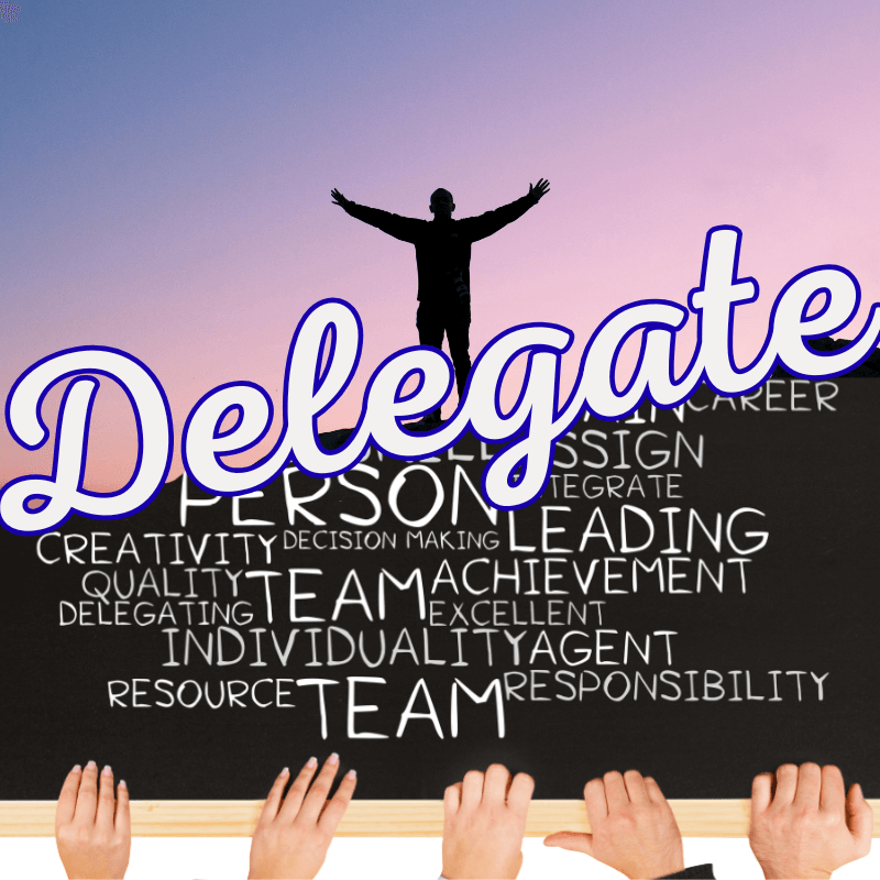 A manager standing with open arms above a chalkboard filled with teamwork and leadership words, symbolizing the shift from doing work to delegating with clarity.